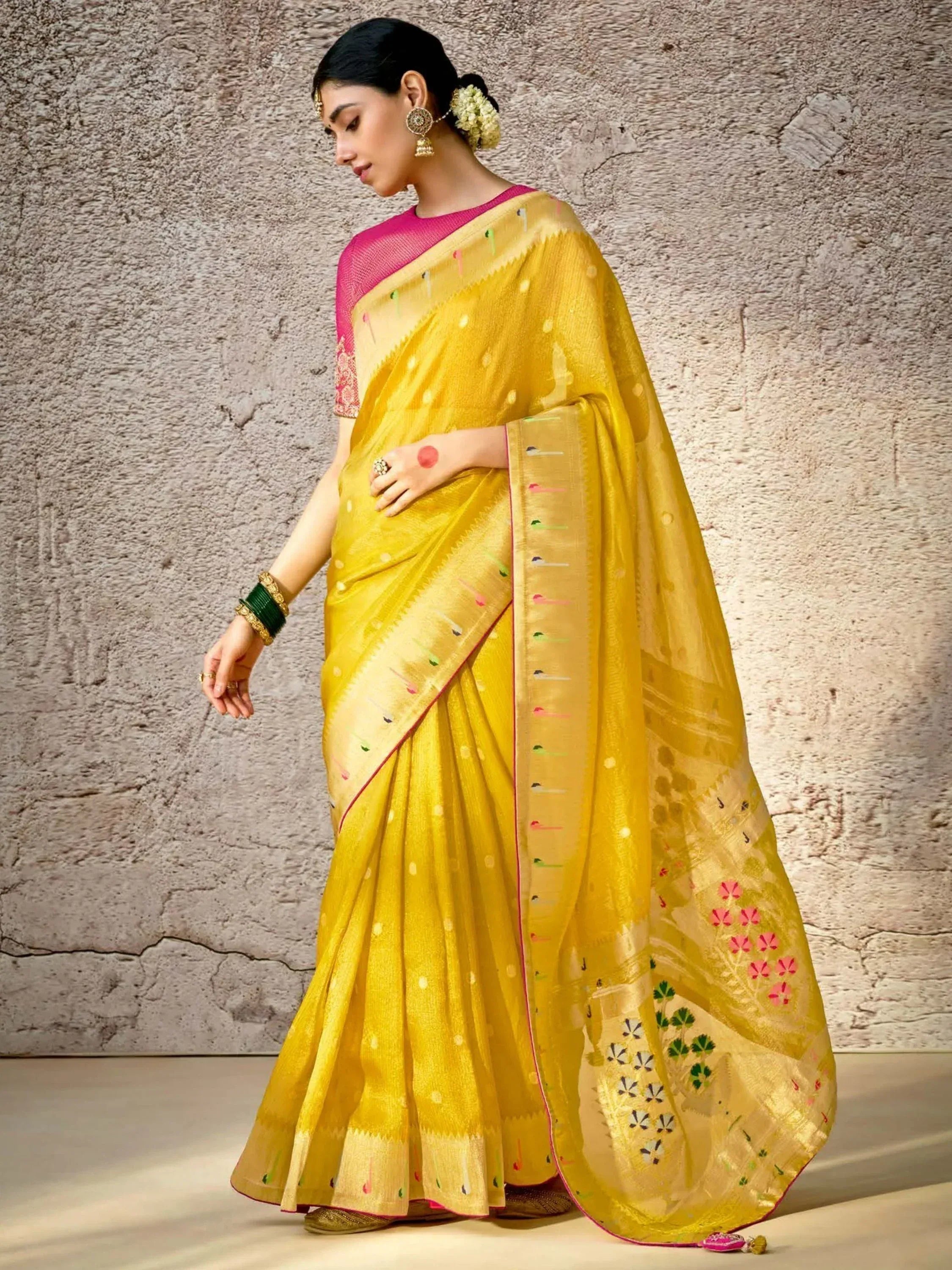 Yellow embroidered saree with pink blouse, floral motifs, and traditional Indian jewelry for ethnic wear
