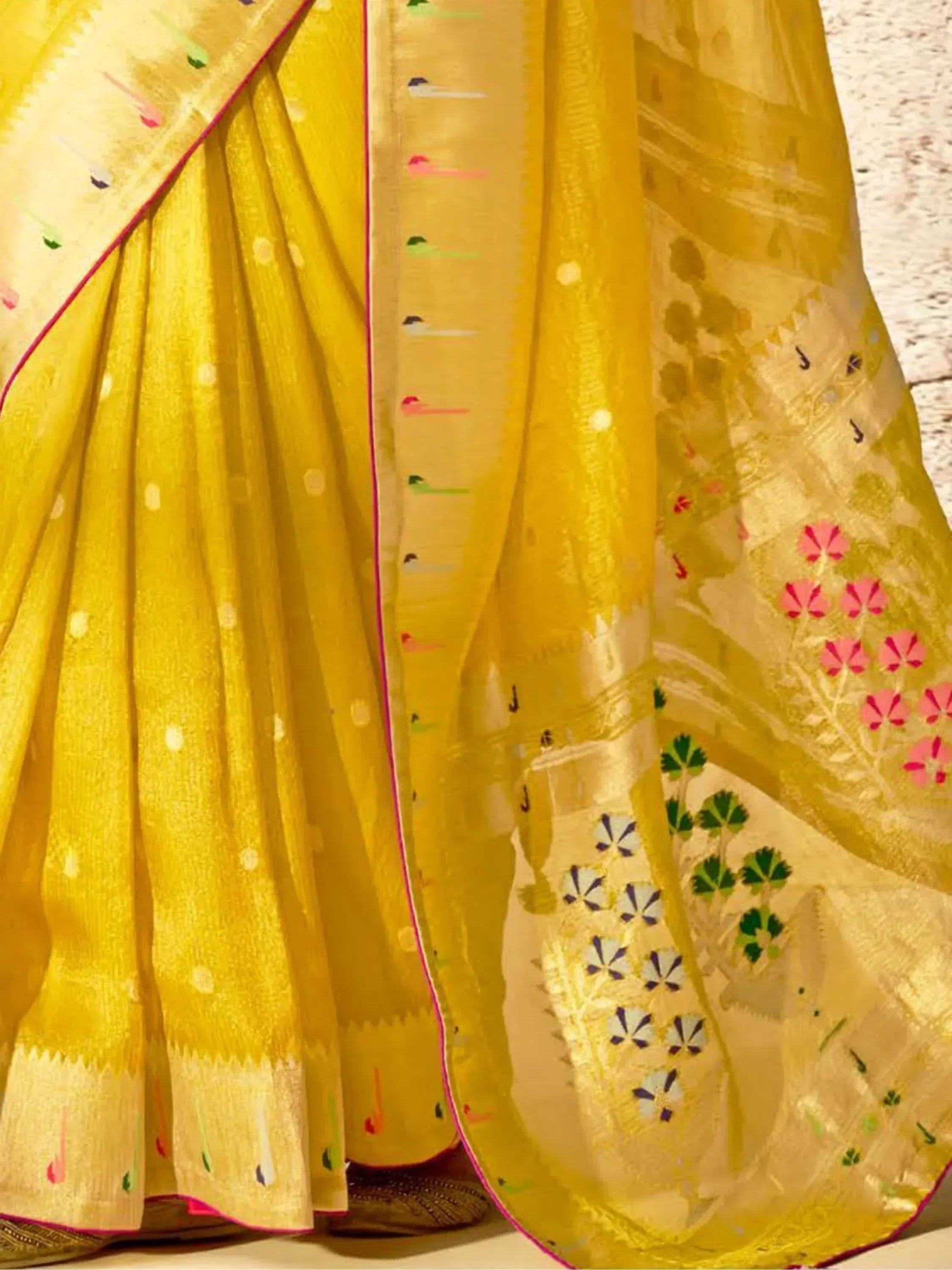 Yellow designer saree with floral and geometric embroidery, perfect for ethnic wear occasions.