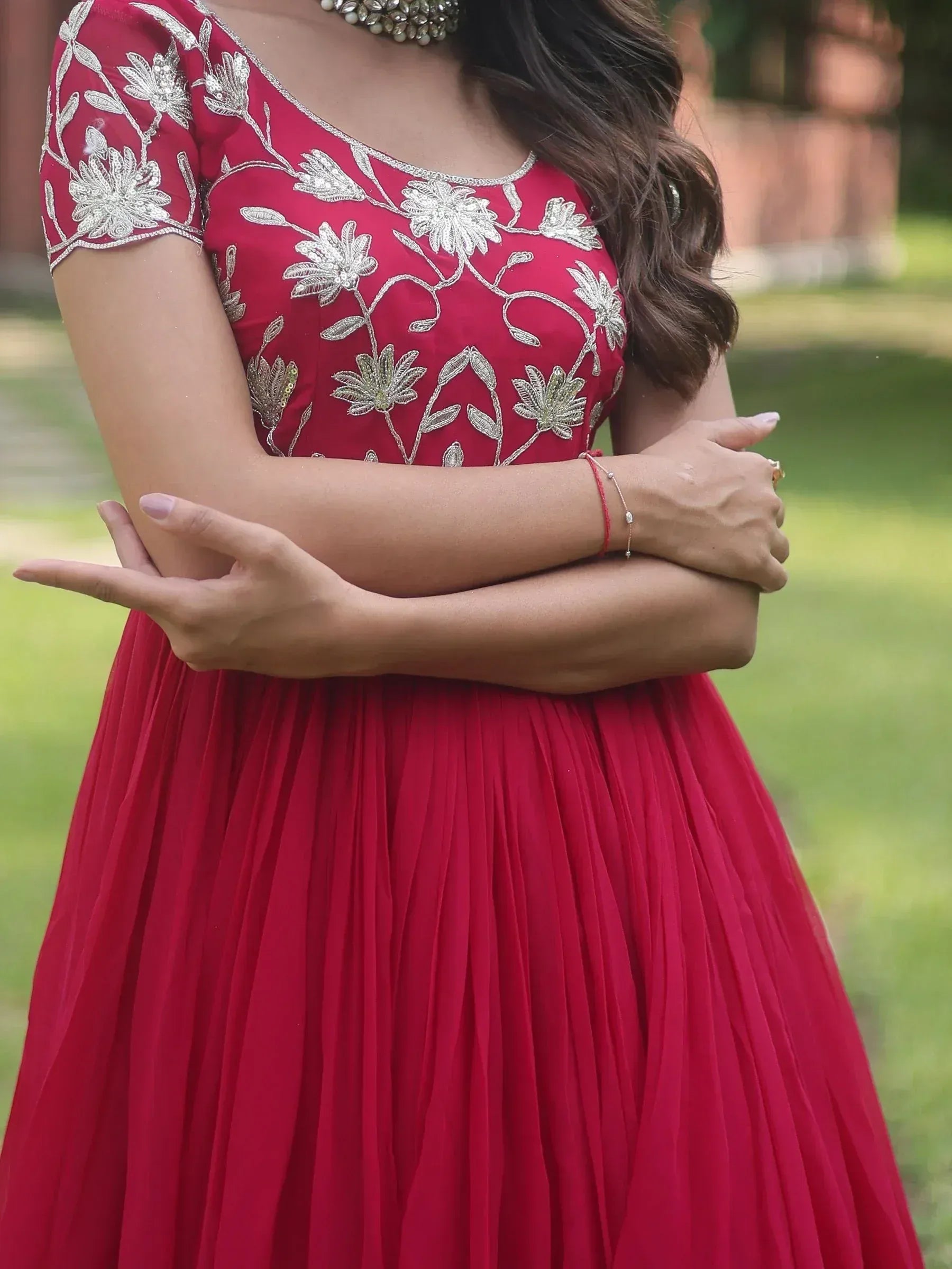 Red ethnic gown with silver floral embroidery, pleated skirt, perfect for Indian weddings or festive occasions