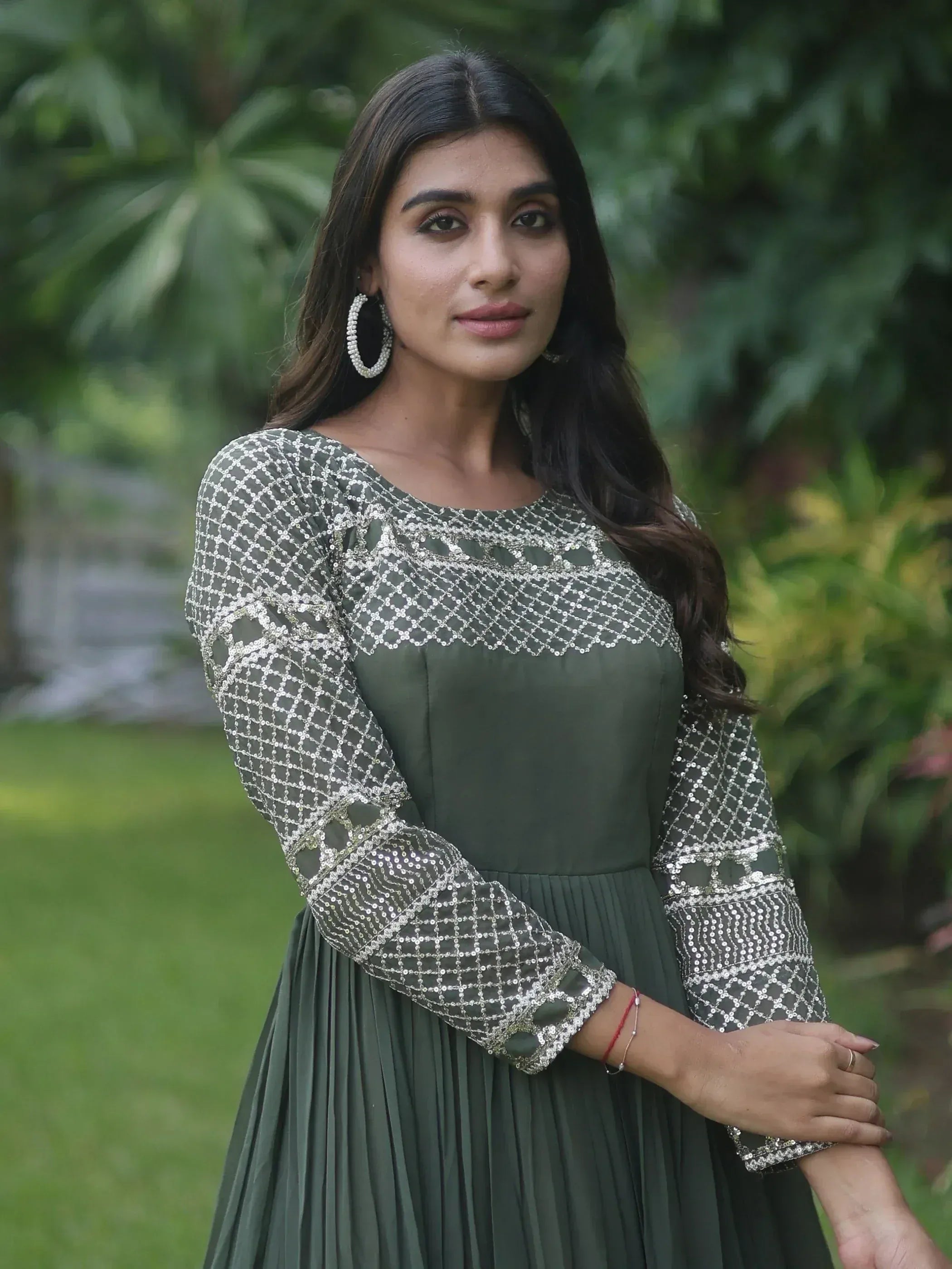 Olive green ethnic gown with silver sequin embroidery, perfect for Indian occasions and parties.