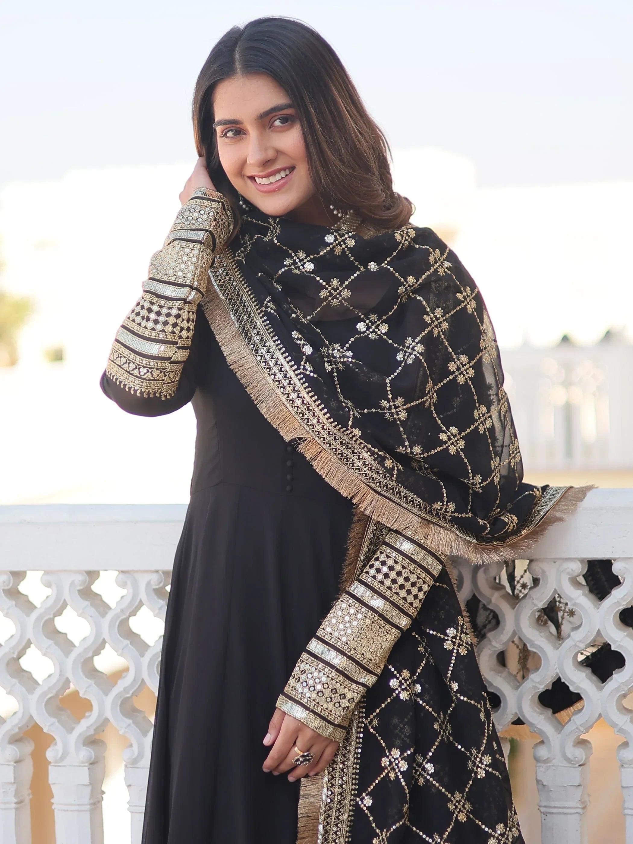 Woman in black and gold embroidered salwar kameez with dupatta, Indian ethnic wear