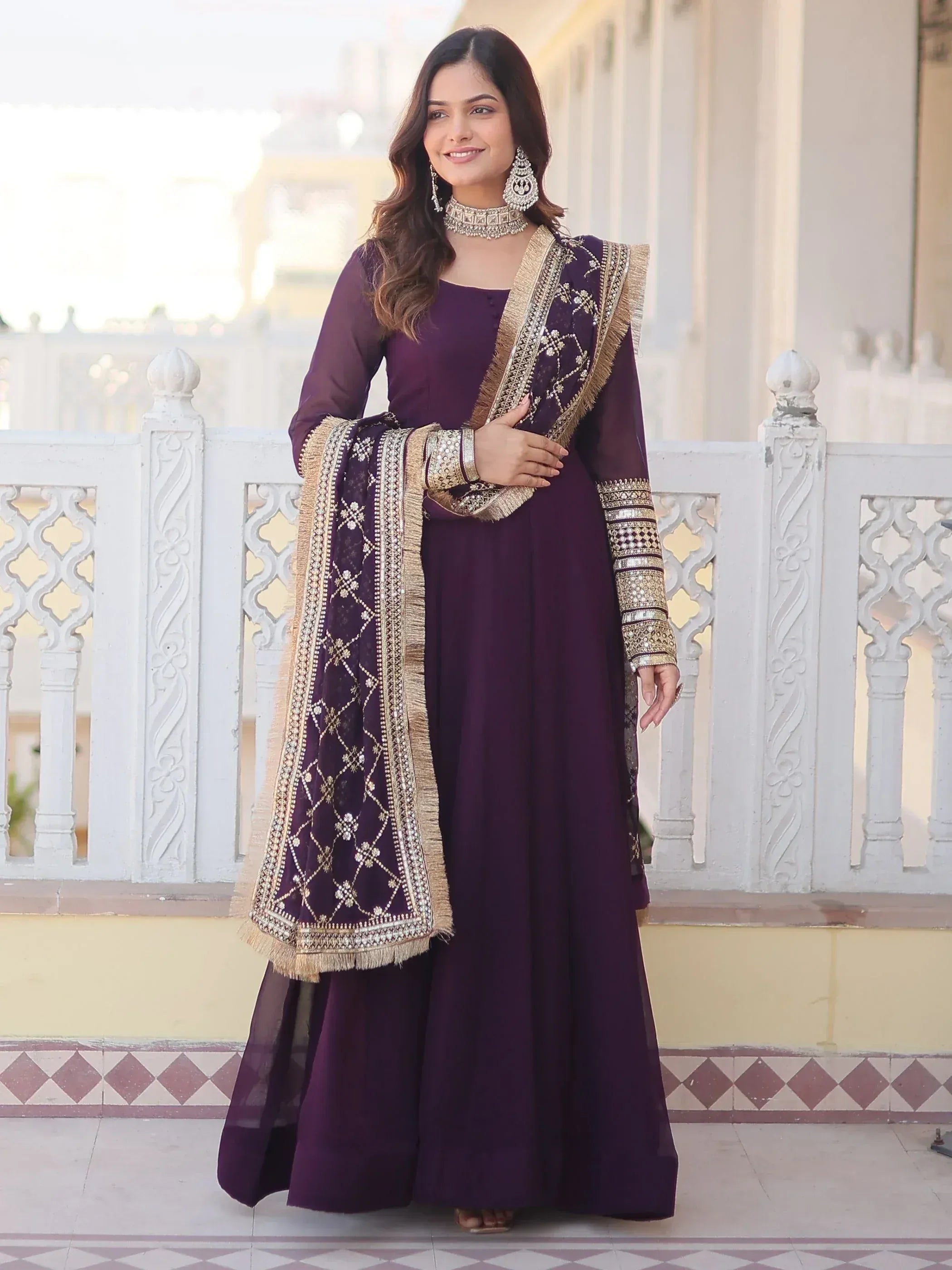 Elegant purple Indian ethnic gown with gold embroidery and dupatta, perfect for festive occasions