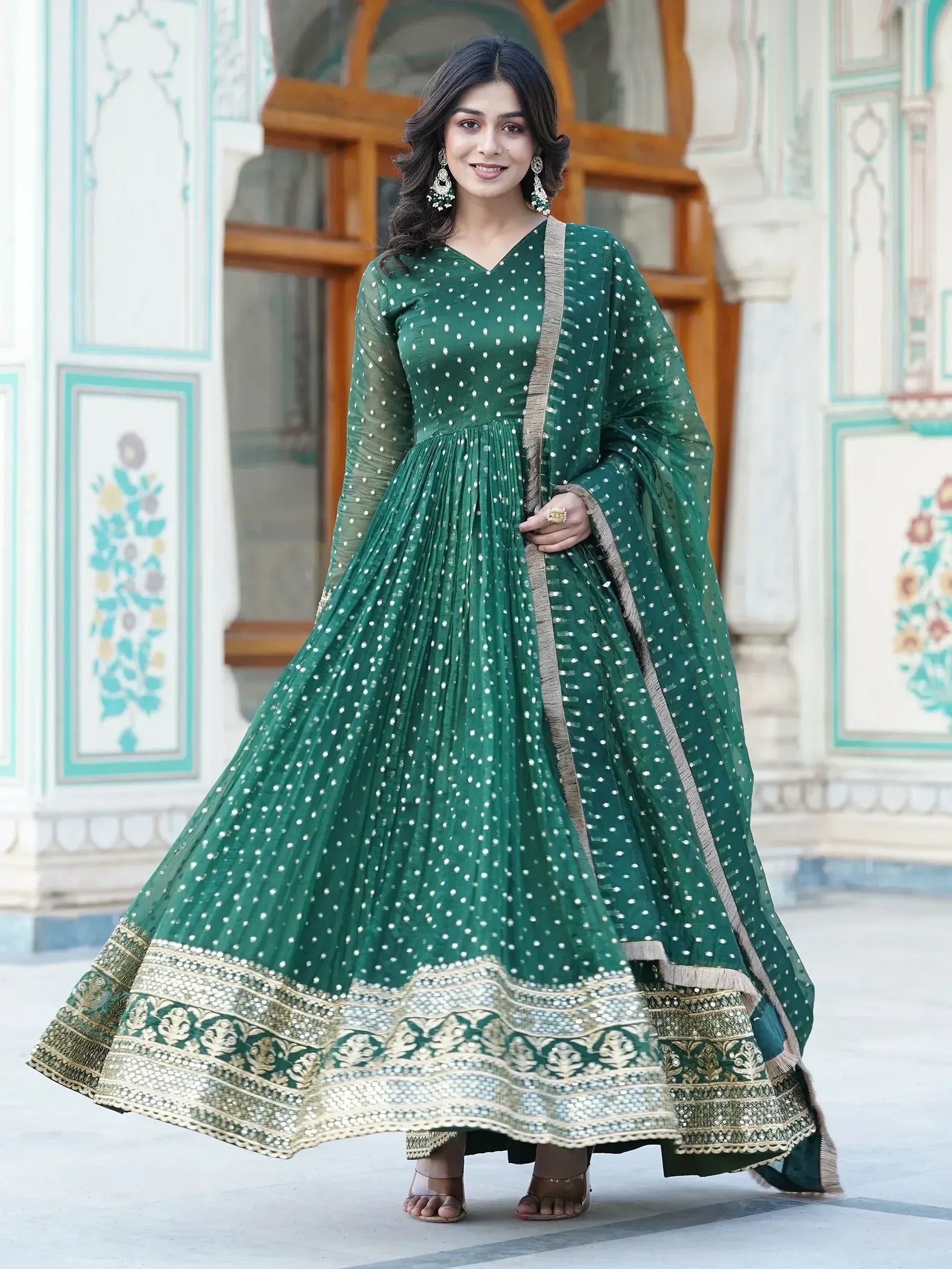 Emerald green ethnic anarkali with white polka dots and gold embroidery, perfect for Indian occasions