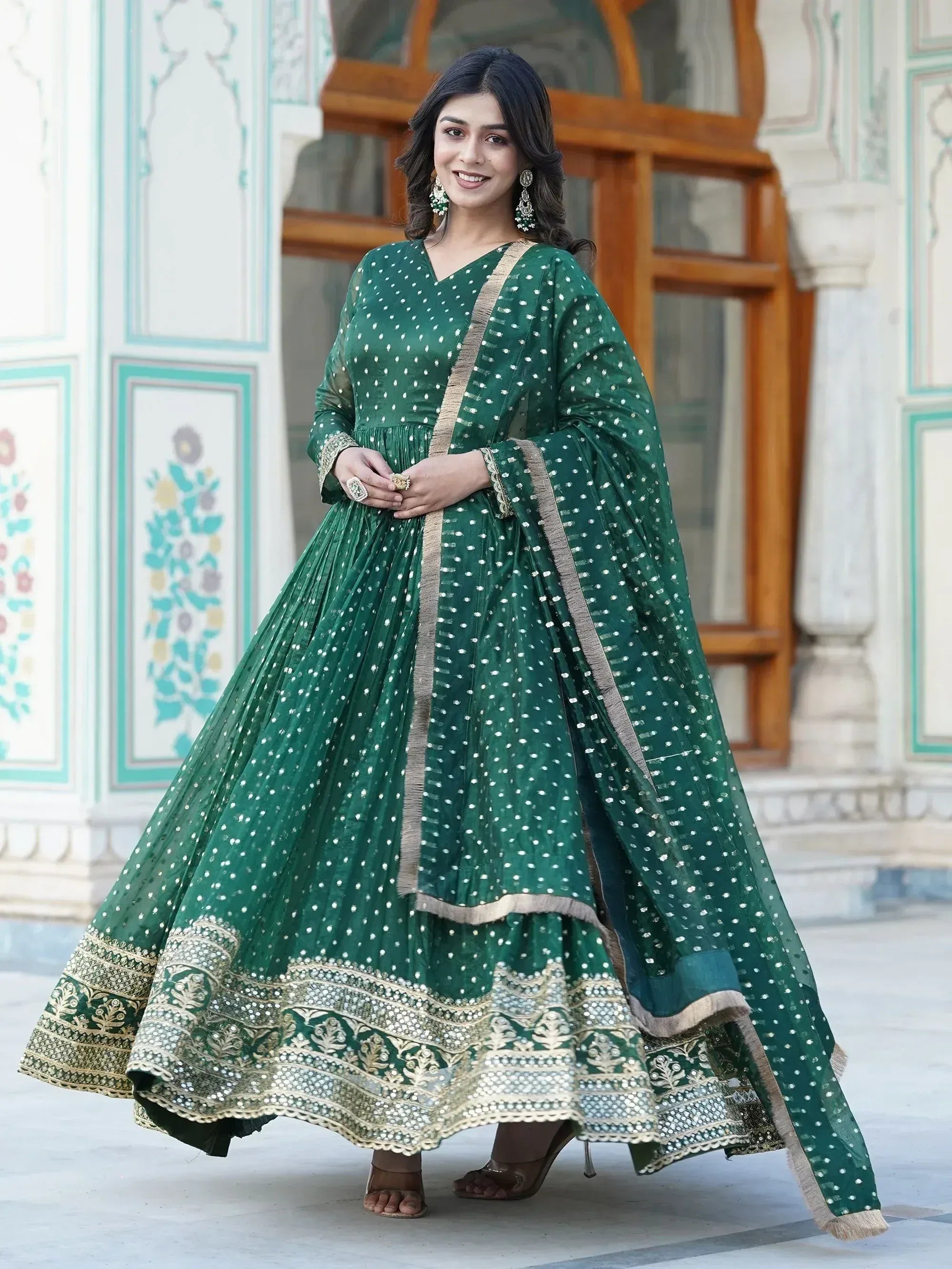 Emerald green ethnic anarkali with gold embroidery and polka dots, perfect for Indian weddings or festive occasions.