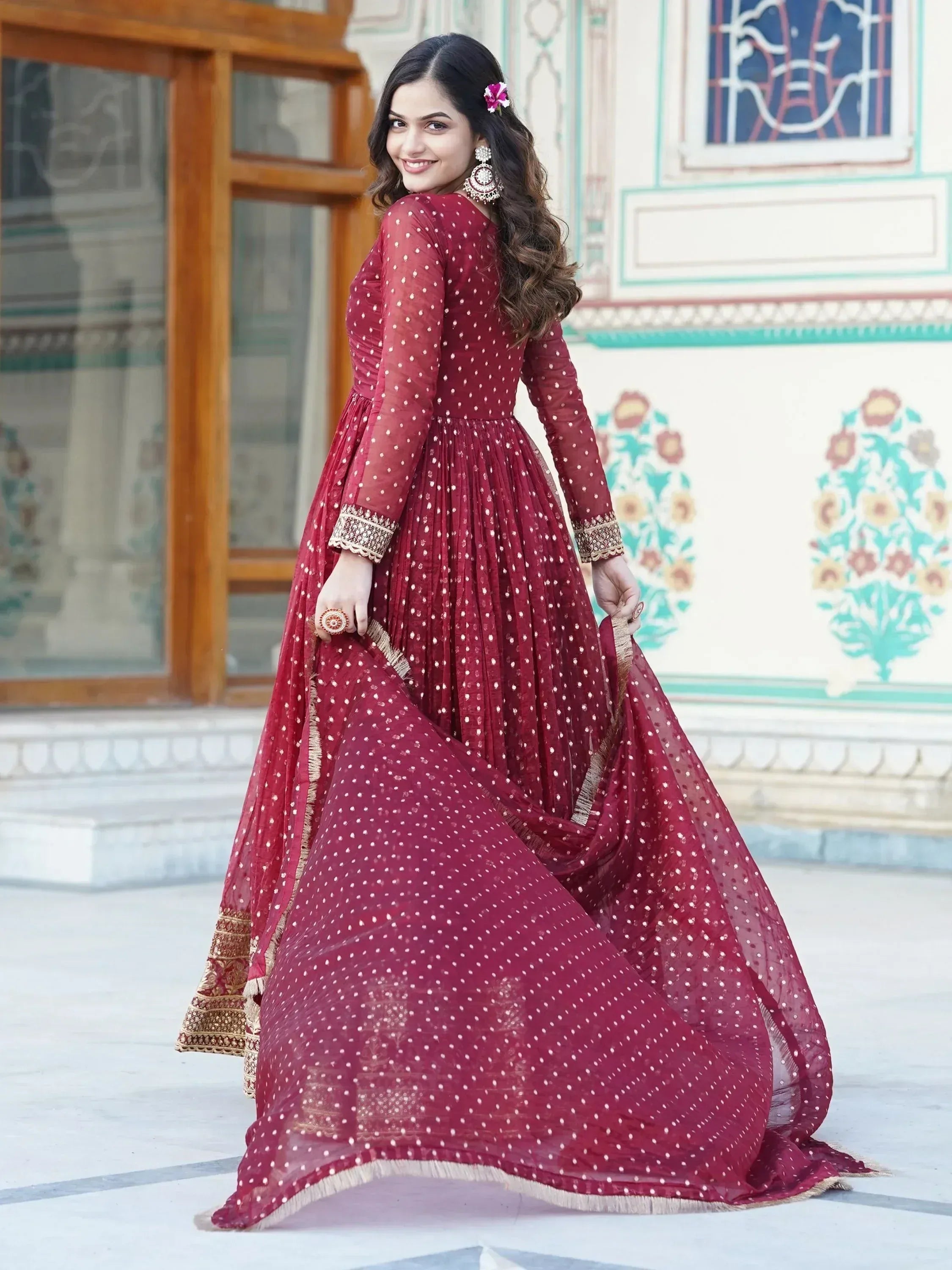 Maroon ethnic gown with white polka dots and gold embroidery, perfect for Indian celebrations