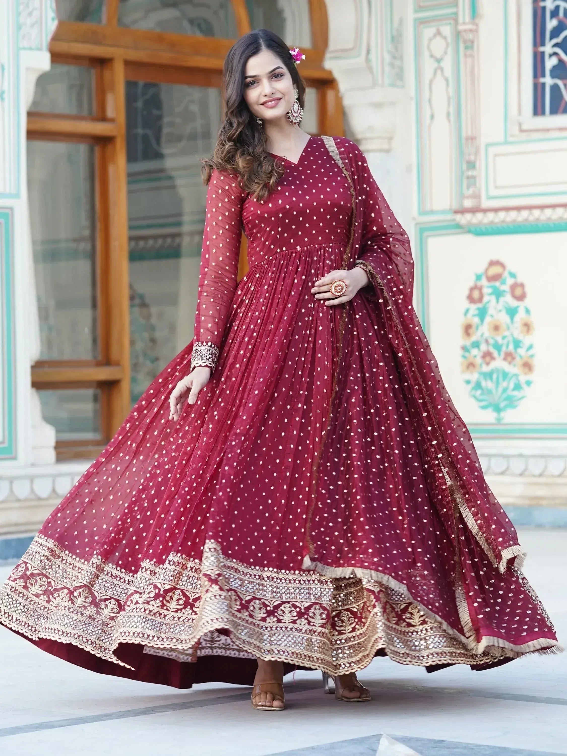 Maroon ethnic gown with white polka dots and gold embroidery, perfect for Indian occasions