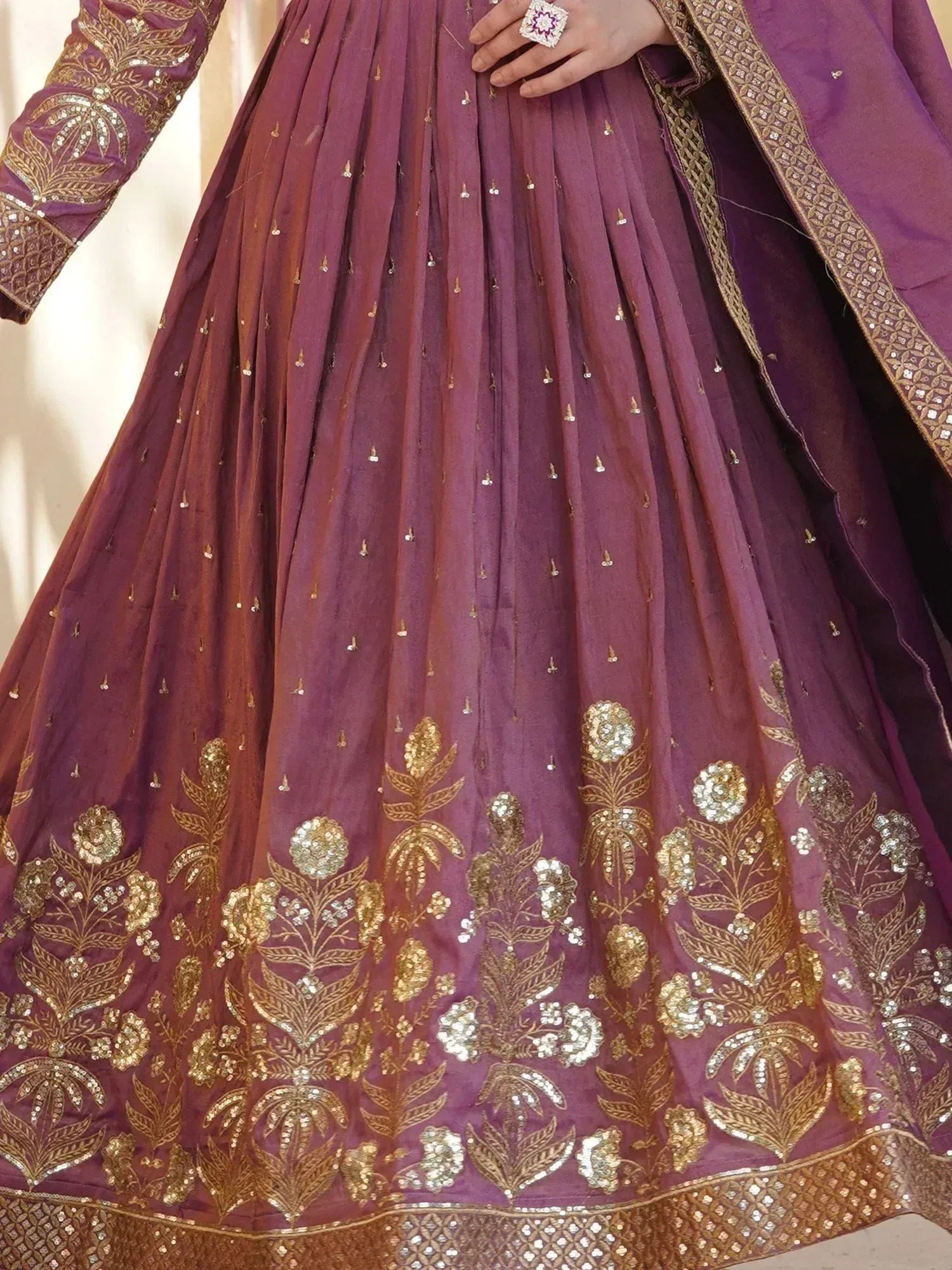 Purple ethnic lehenga with gold floral embroidery and sequin detailing, perfect for weddings and festivals.
