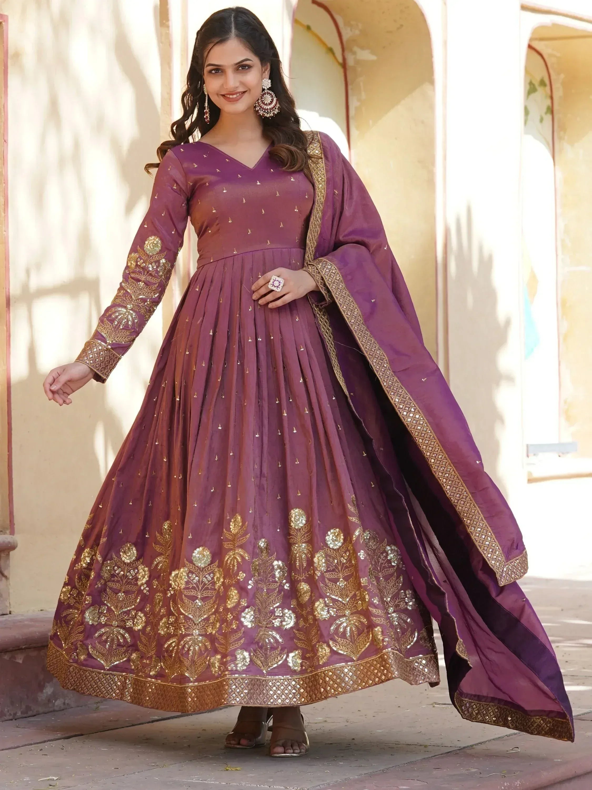 Purple ethnic anarkali gown with gold embroidery, perfect for Indian weddings and festive occasions.