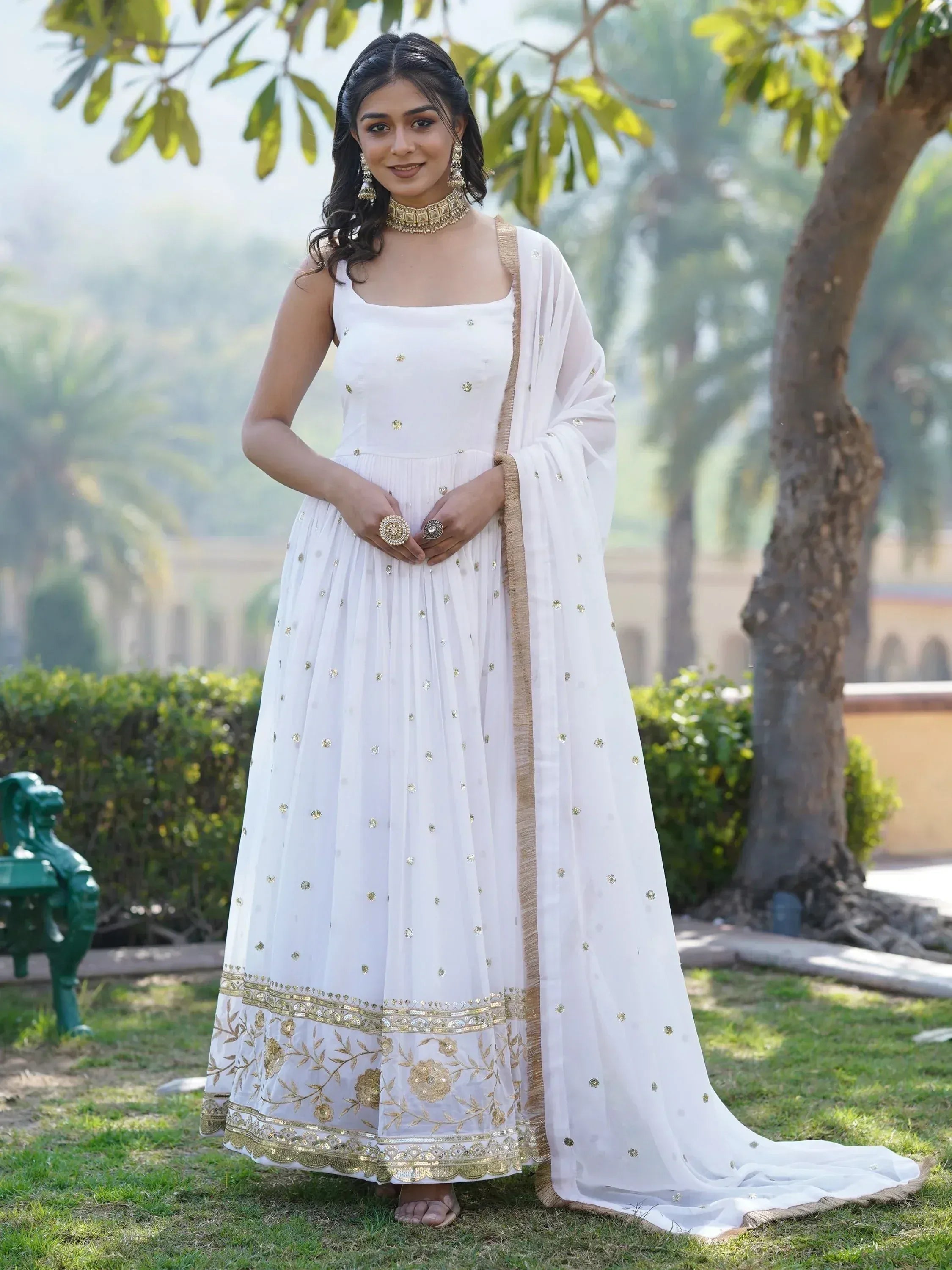 White ethnic gown with gold embroidery, perfect for Indian occasions and festive events.