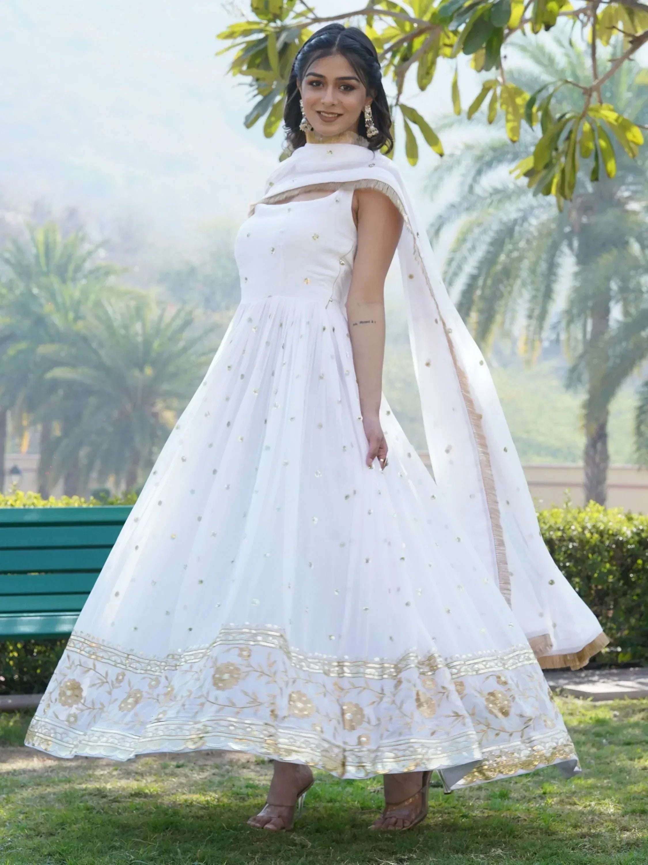 White ethnic gown with gold embroidery and dupatta, perfect for Indian occasions