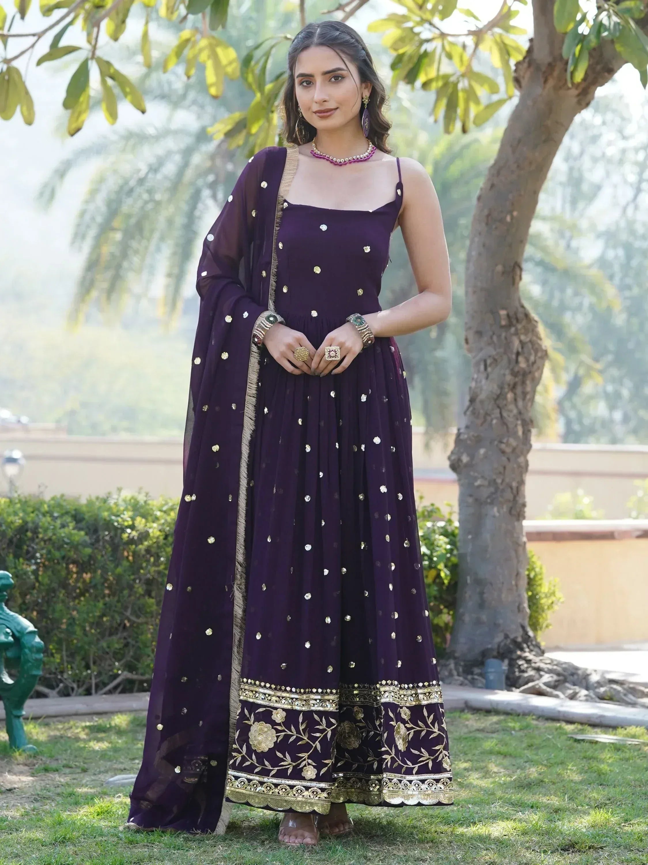Purple ethnic gown with gold embroidery and matching dupatta, perfect for Indian occasions