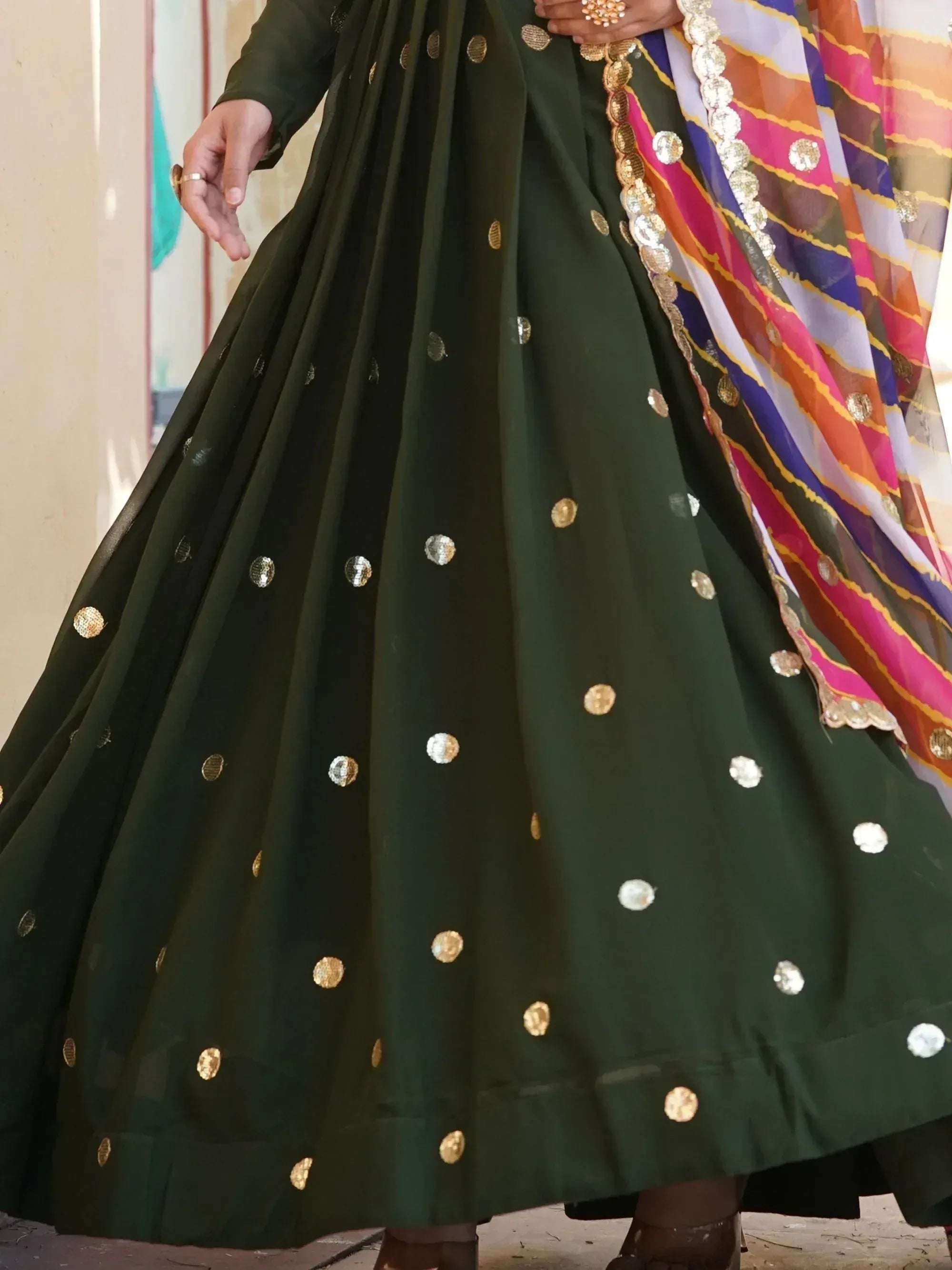 Green ethnic lehenga with gold mirror work and colorful dupatta, perfect for Indian festive wear