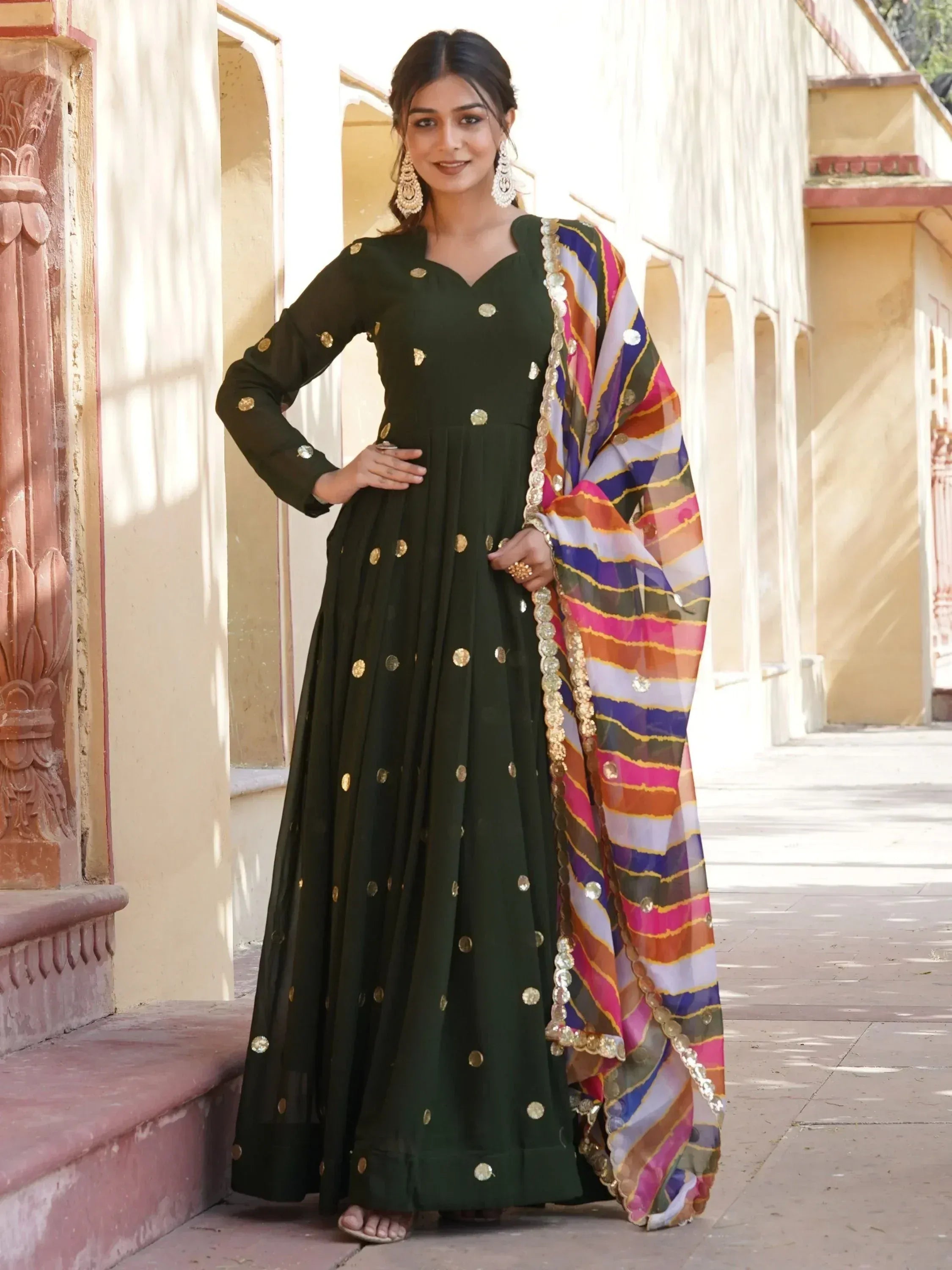 Green ethnic anarkali with gold mirror work and colorful striped dupatta, perfect for Indian occasions