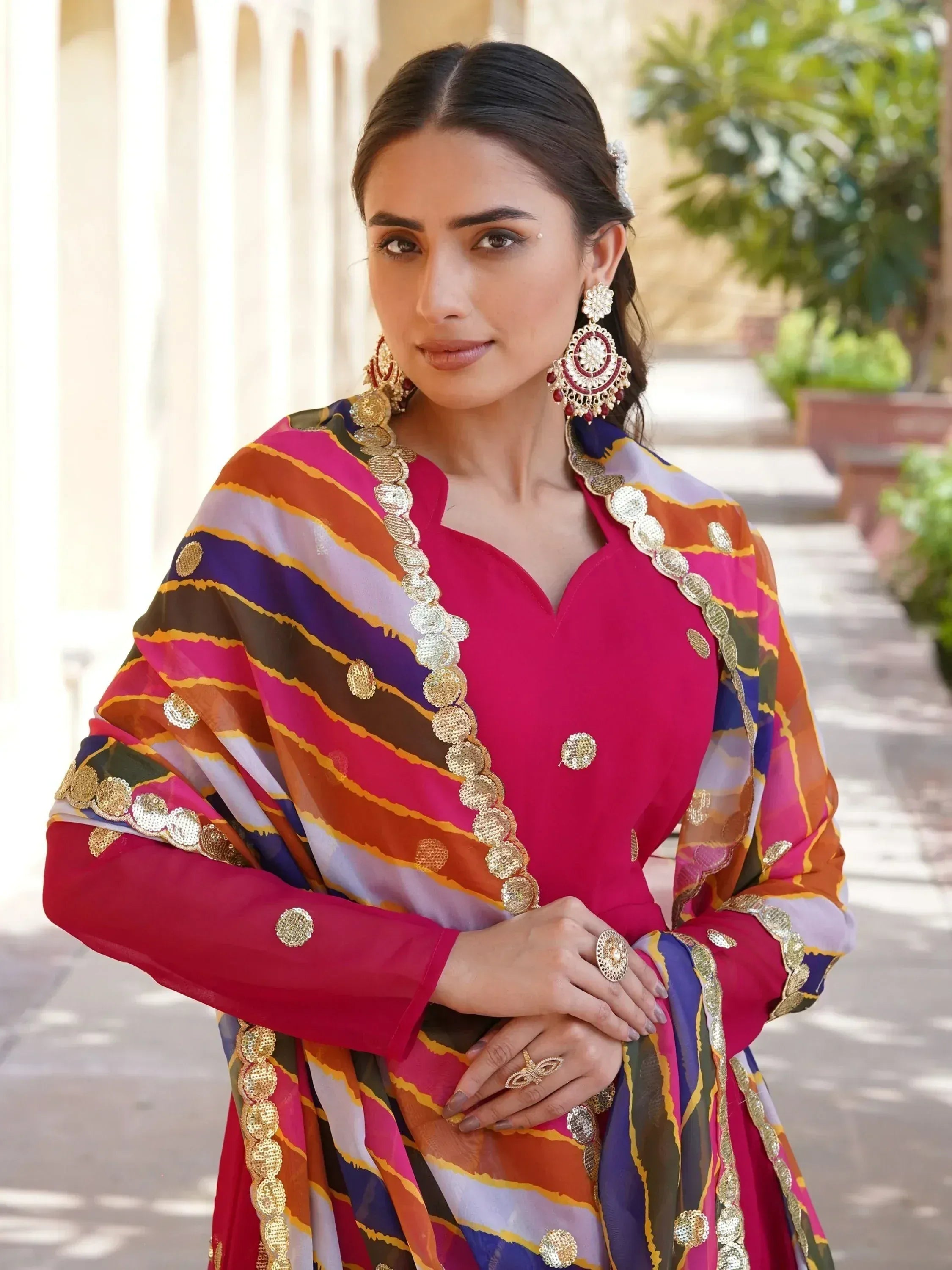 Vibrant Indian ethnic wear with colorful striped dupatta and gold embellishments, perfect for festive occasions.