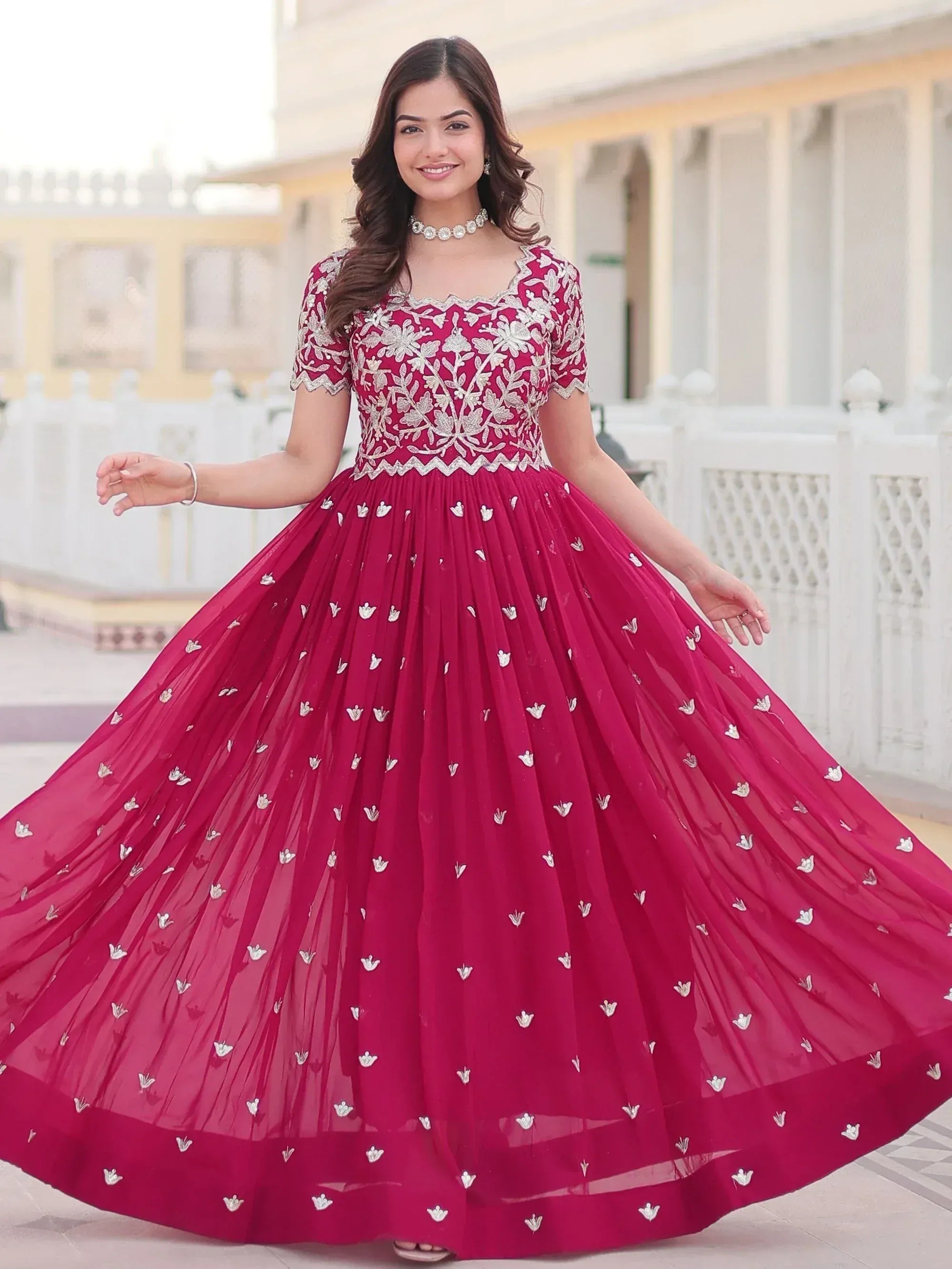 Woman in maroon ethnic gown with silver floral embroidery, perfect for Indian weddings and parties