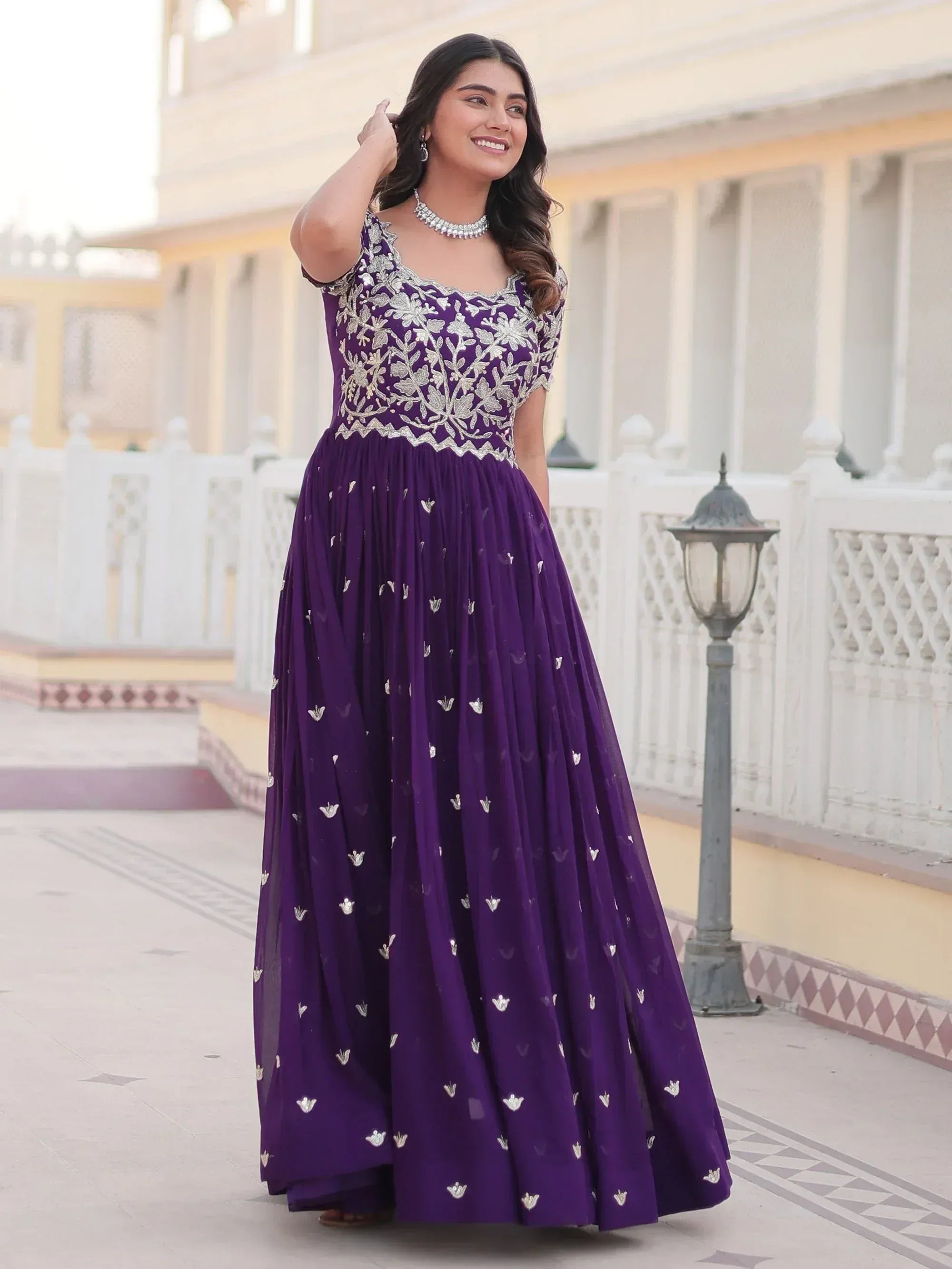 Purple embroidered ethnic gown with floral detailing, perfect for Indian occasions and festive events.