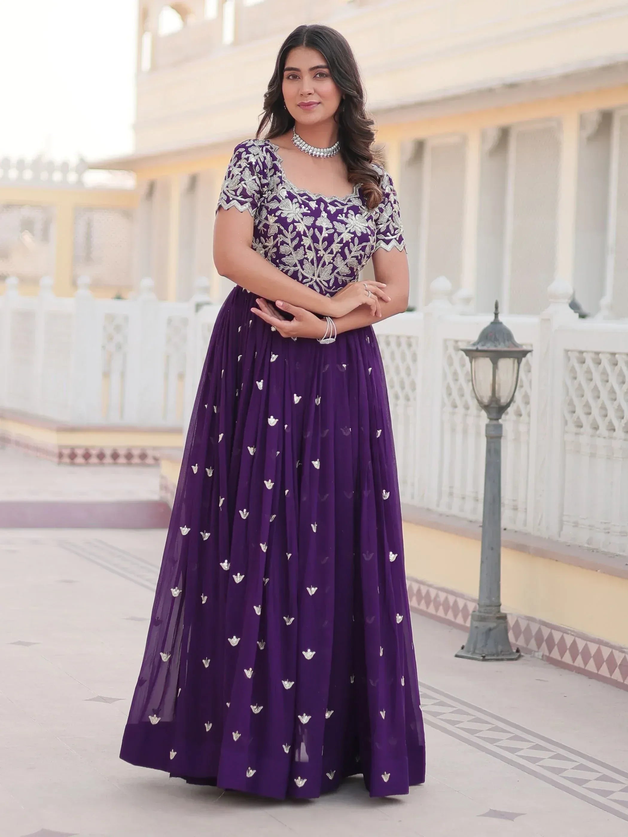 Purple embroidered ethnic gown with silver floral work, perfect for Indian weddings and festive occasions