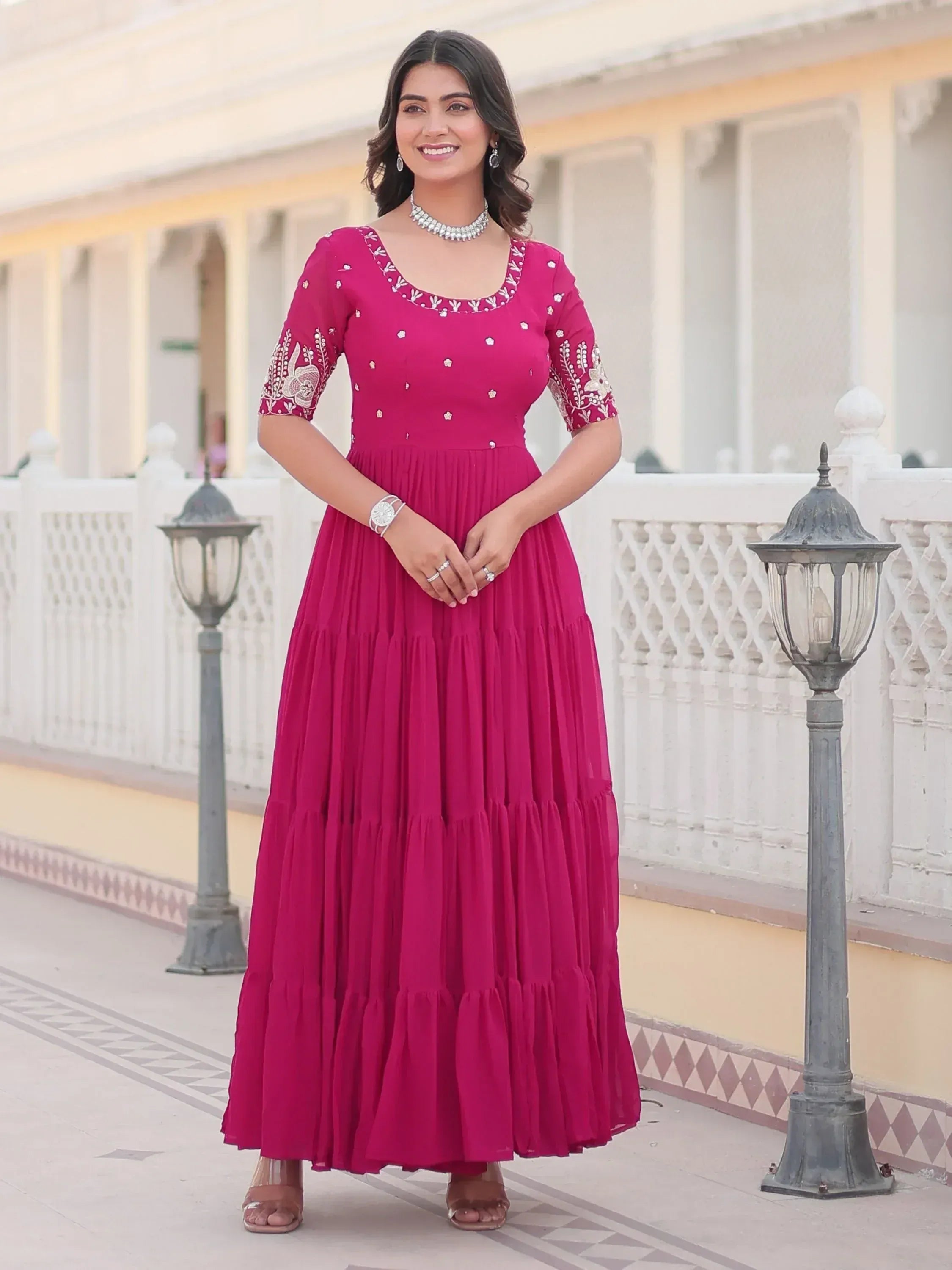 Woman in magenta ethnic gown with embroidery, perfect for Indian occasions and festive wear