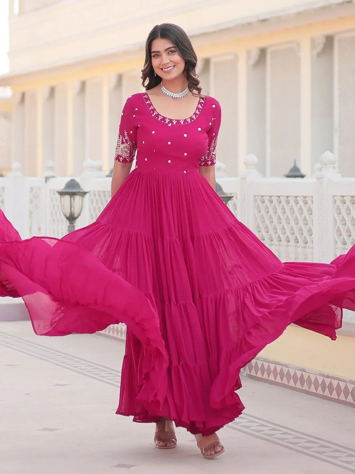 Vibrant pink ethnic gown with embroidery, perfect for Indian occasions and festive wear
