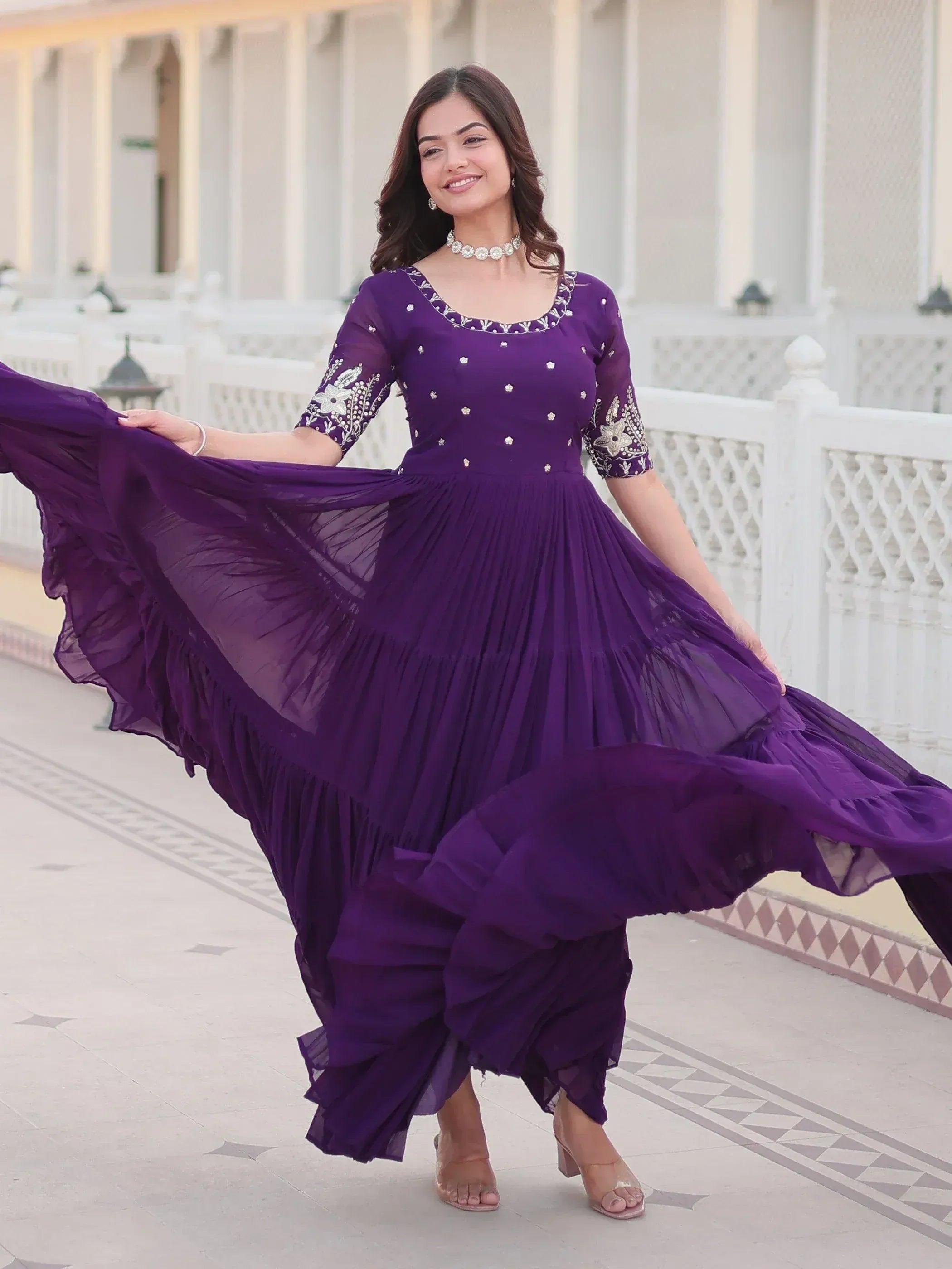 Purple ethnic gown with floral embroidery and pleated skirt, perfect for Indian occasions