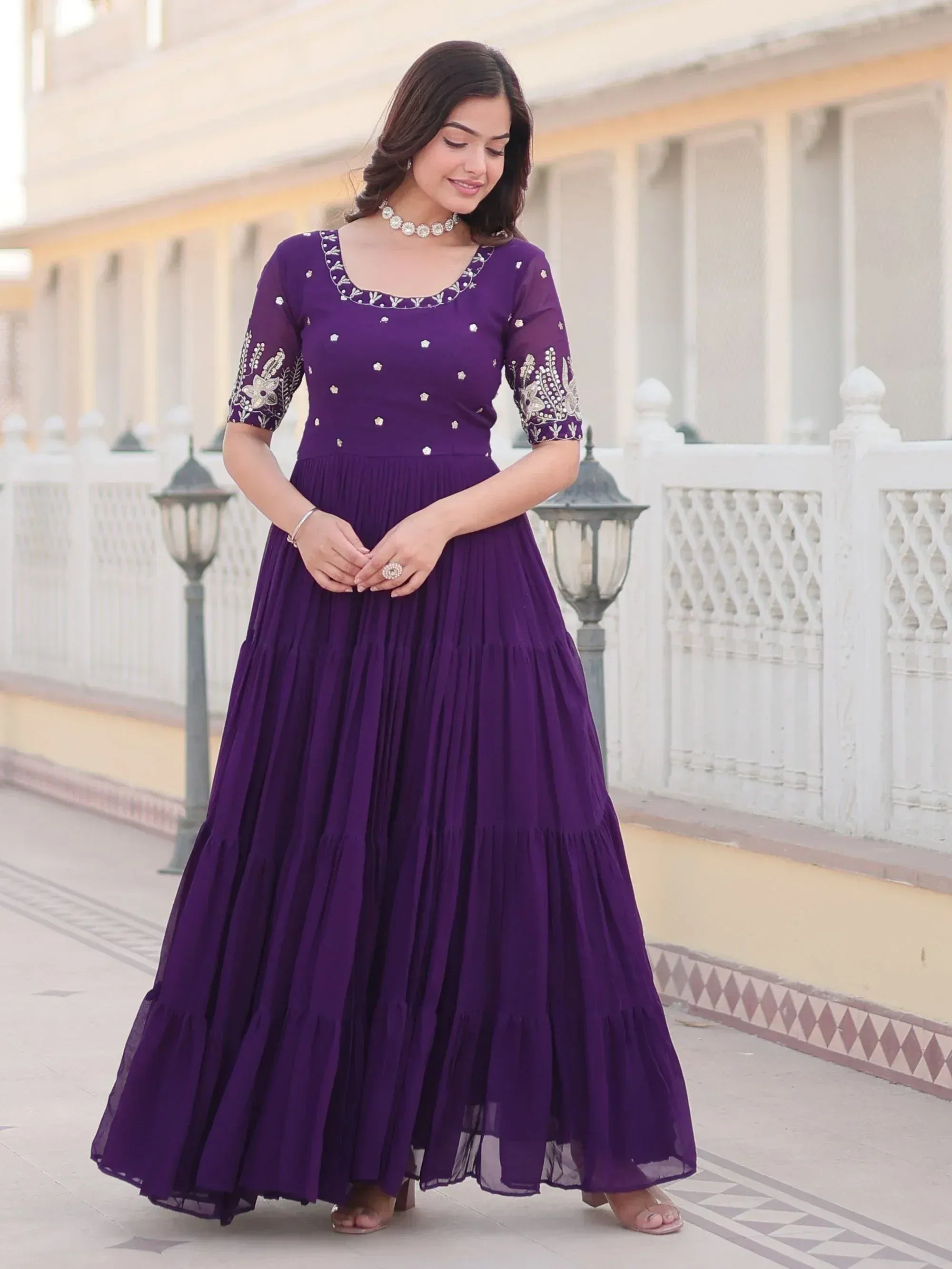 Purple embroidered ethnic gown with pleated skirt, perfect for Indian occasions and festive wear.