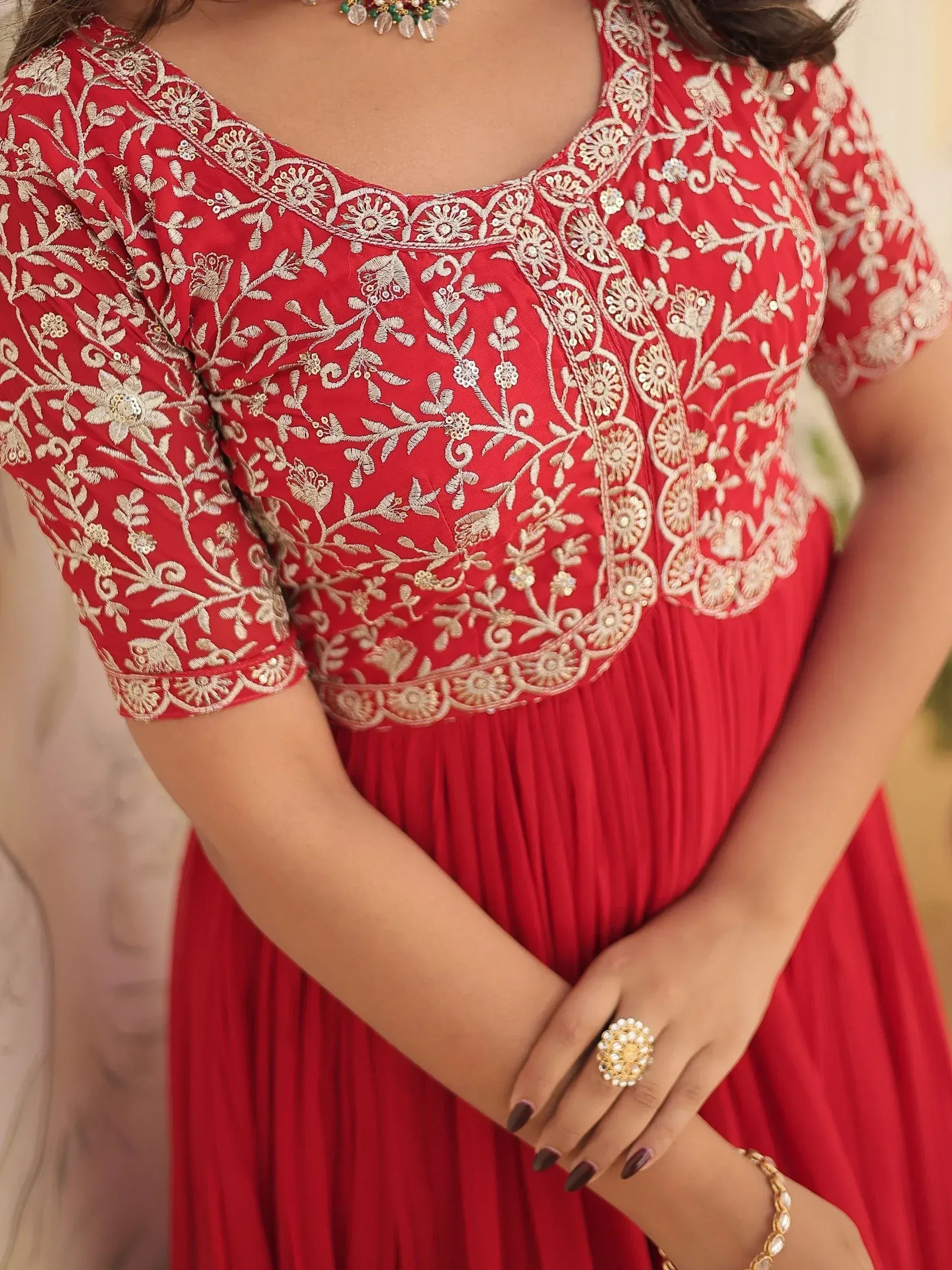 Red ethnic gown with gold floral embroidery, perfect for Indian weddings and festive occasions.