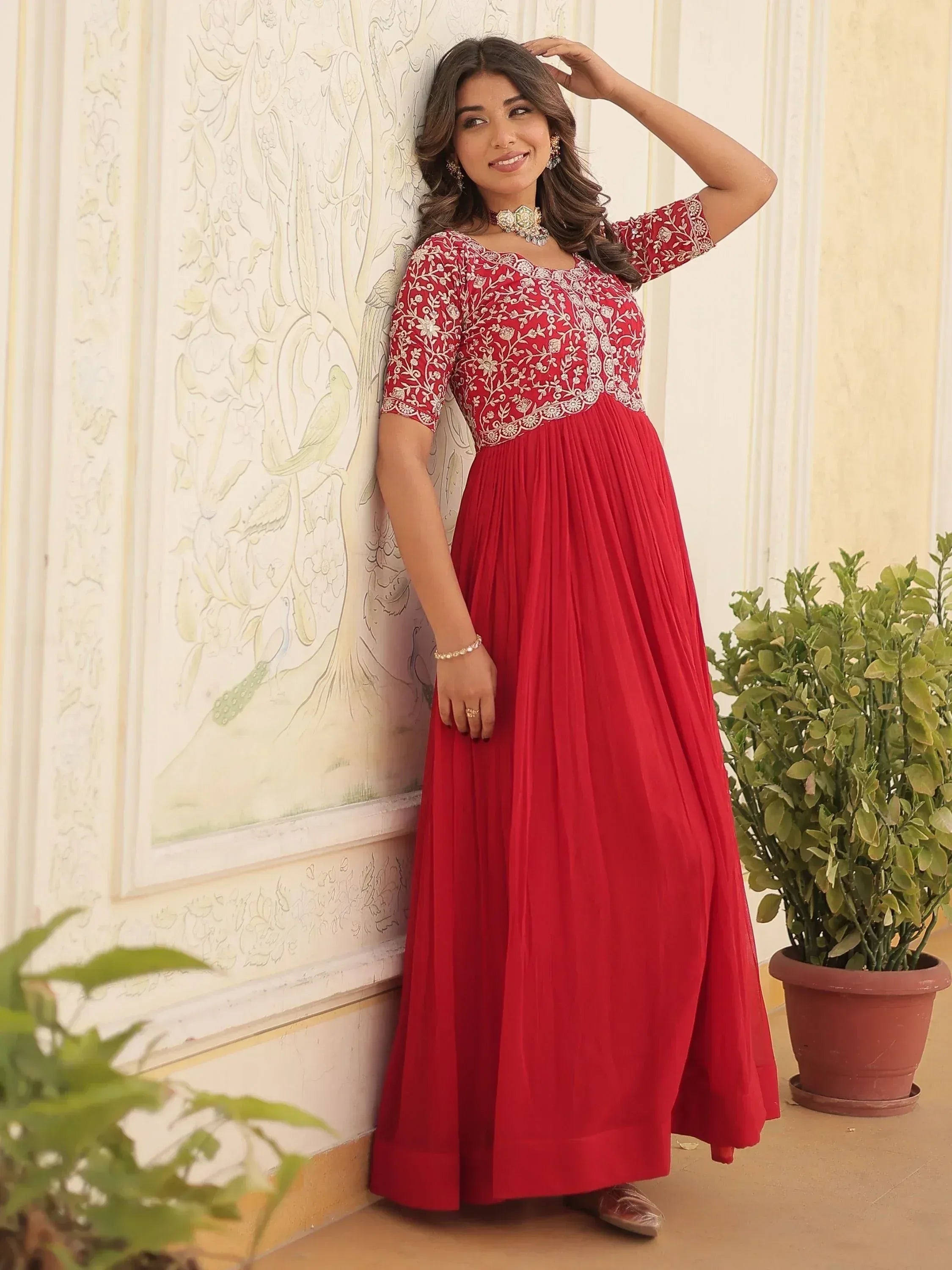 Red embroidered ethnic gown with floral detailing, perfect for Indian occasions and festive wear.