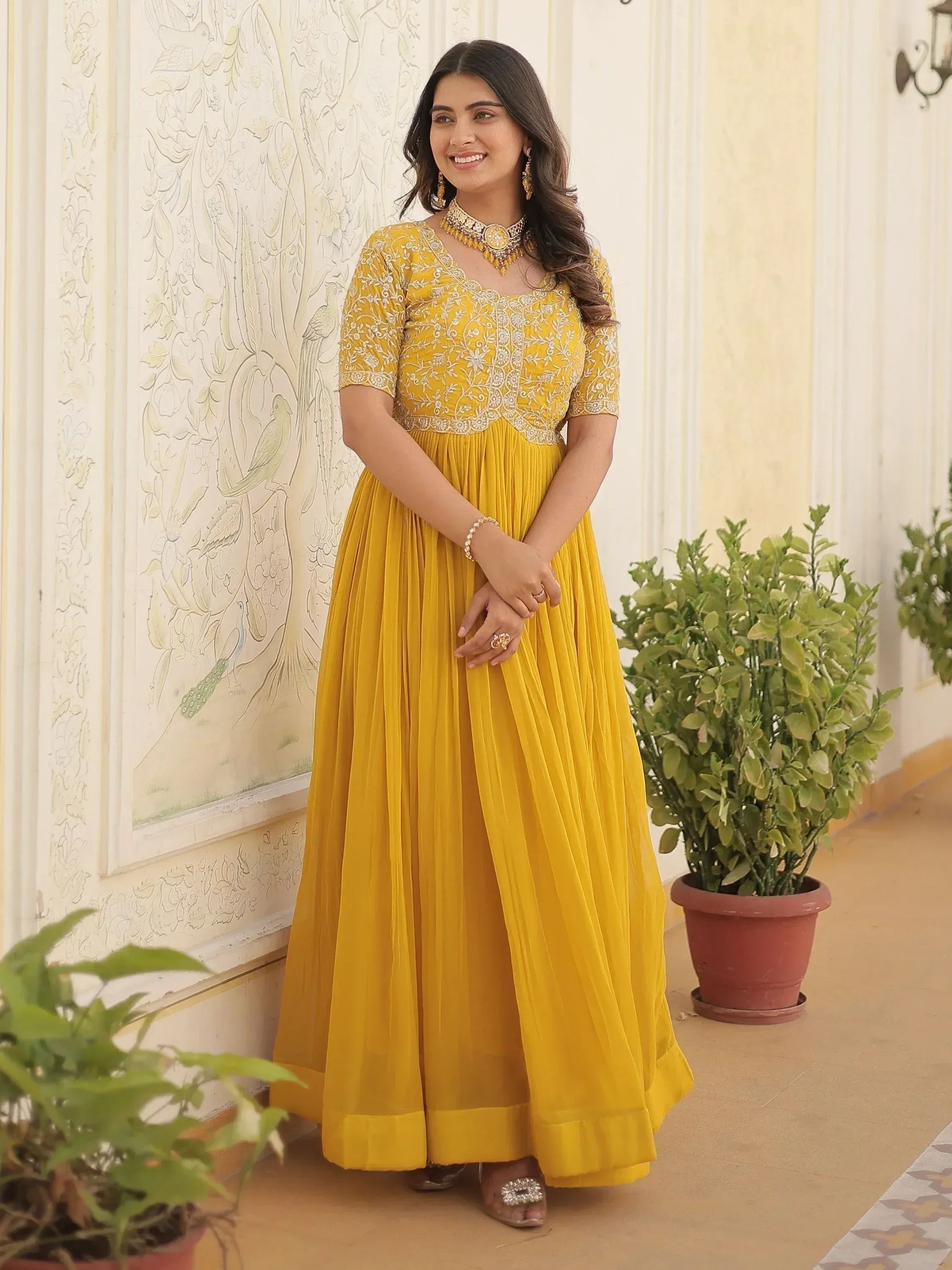 Yellow ethnic gown with floral embroidery, perfect for Indian occasions and festive wear.