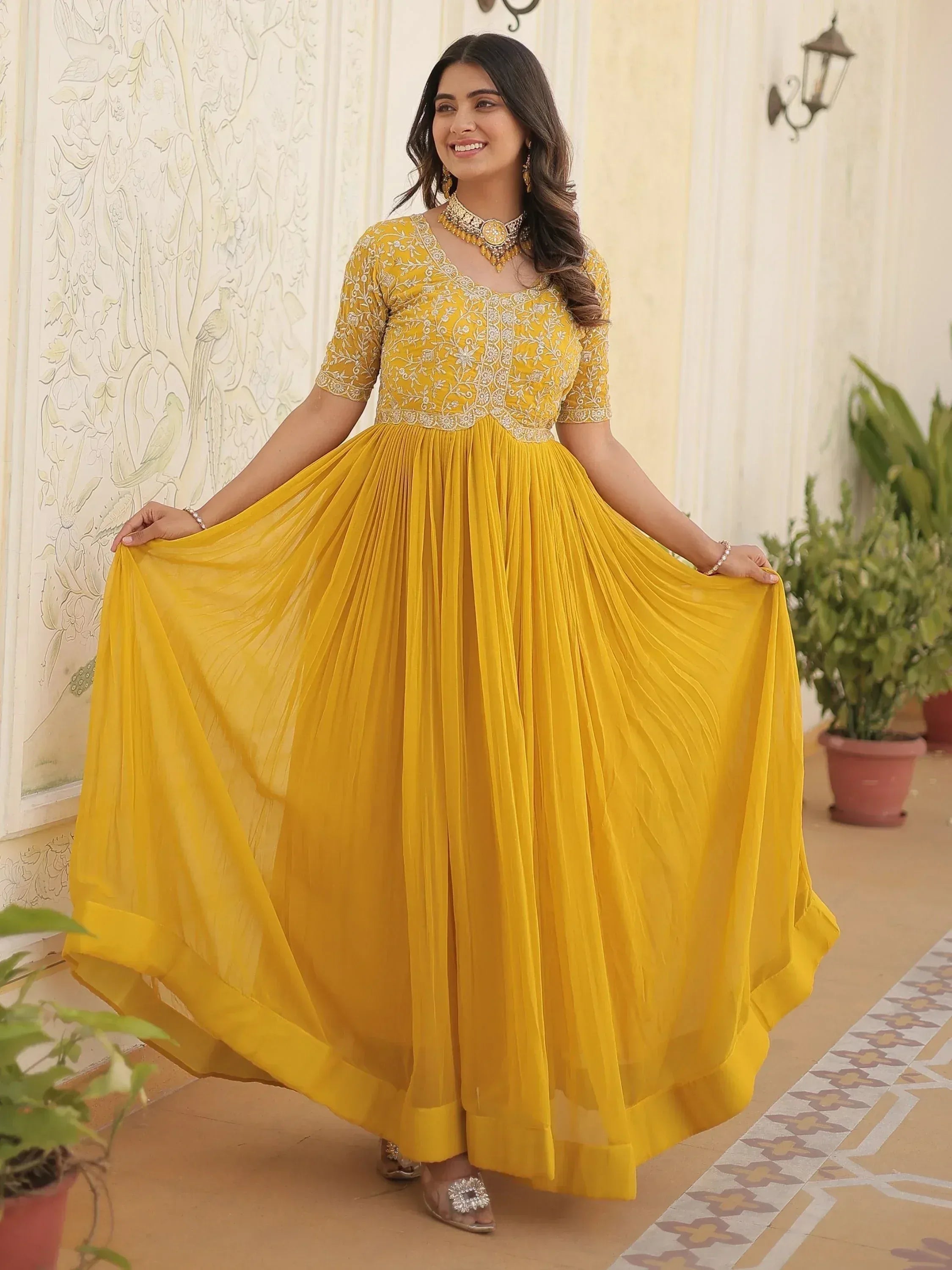 Yellow embroidered ethnic gown with pleated skirt, perfect for Indian occasions and festive wear
