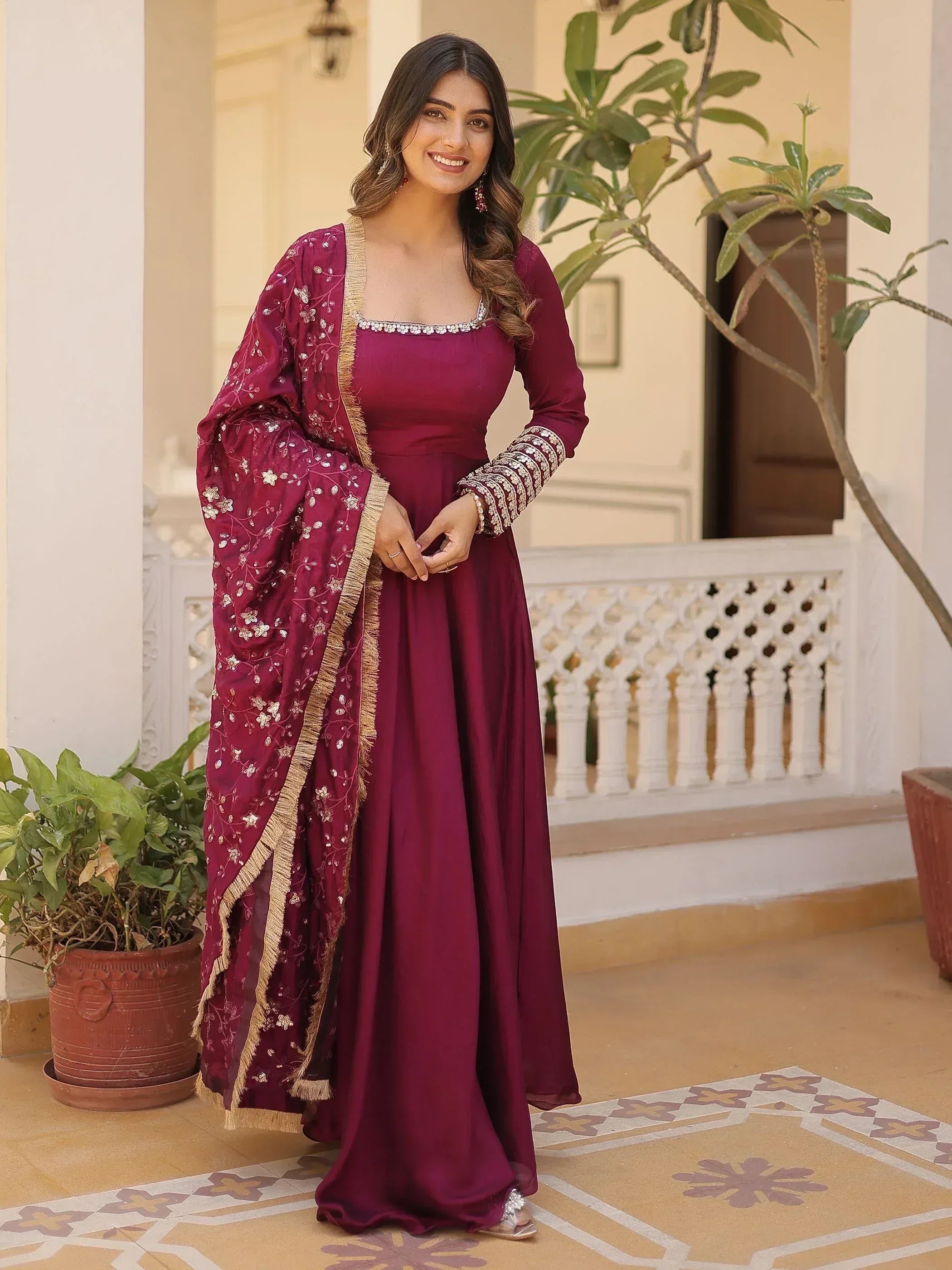Woman in maroon ethnic gown with floral embroidered dupatta, perfect for Indian occasions and weddings