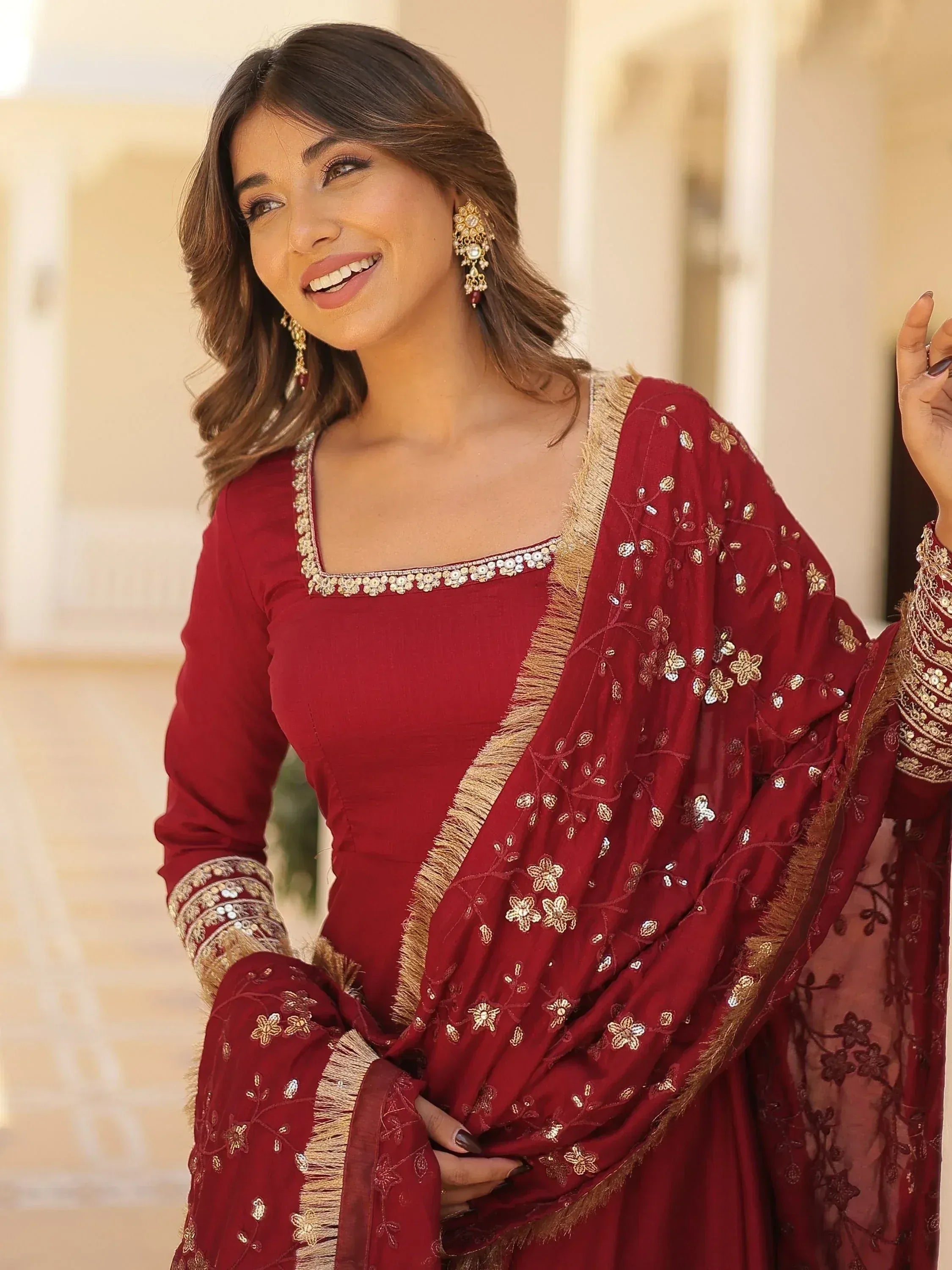 Elegant maroon salwar kameez with gold embroidery and floral dupatta, perfect for Indian ethnic occasions.