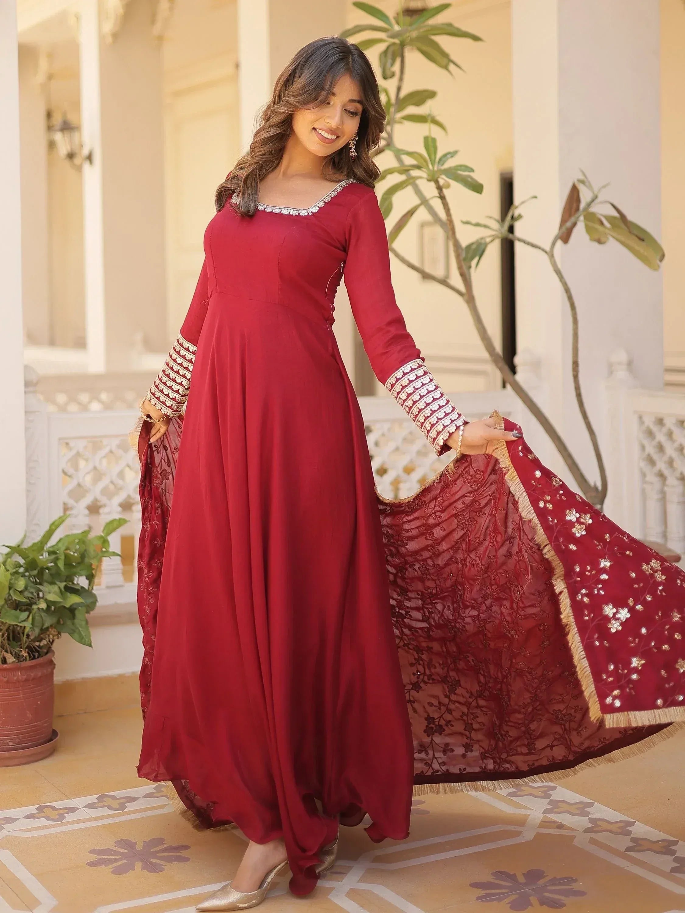 Maroon ethnic gown with embroidered sleeves and dupatta, perfect for Indian occasions