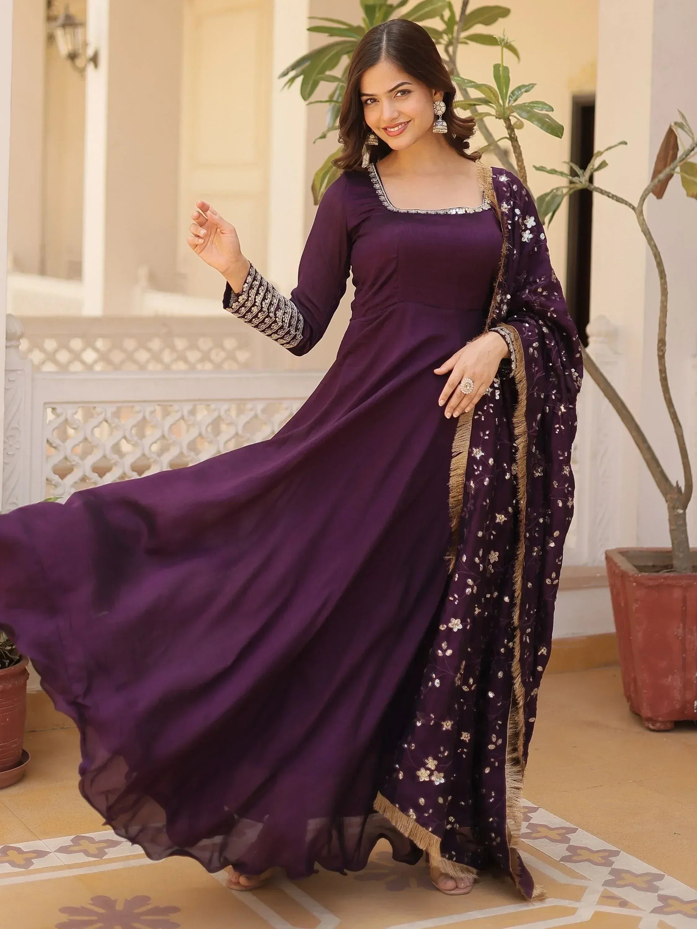 Purple ethnic gown with floral embroidery and gold trim, perfect for Indian occasions