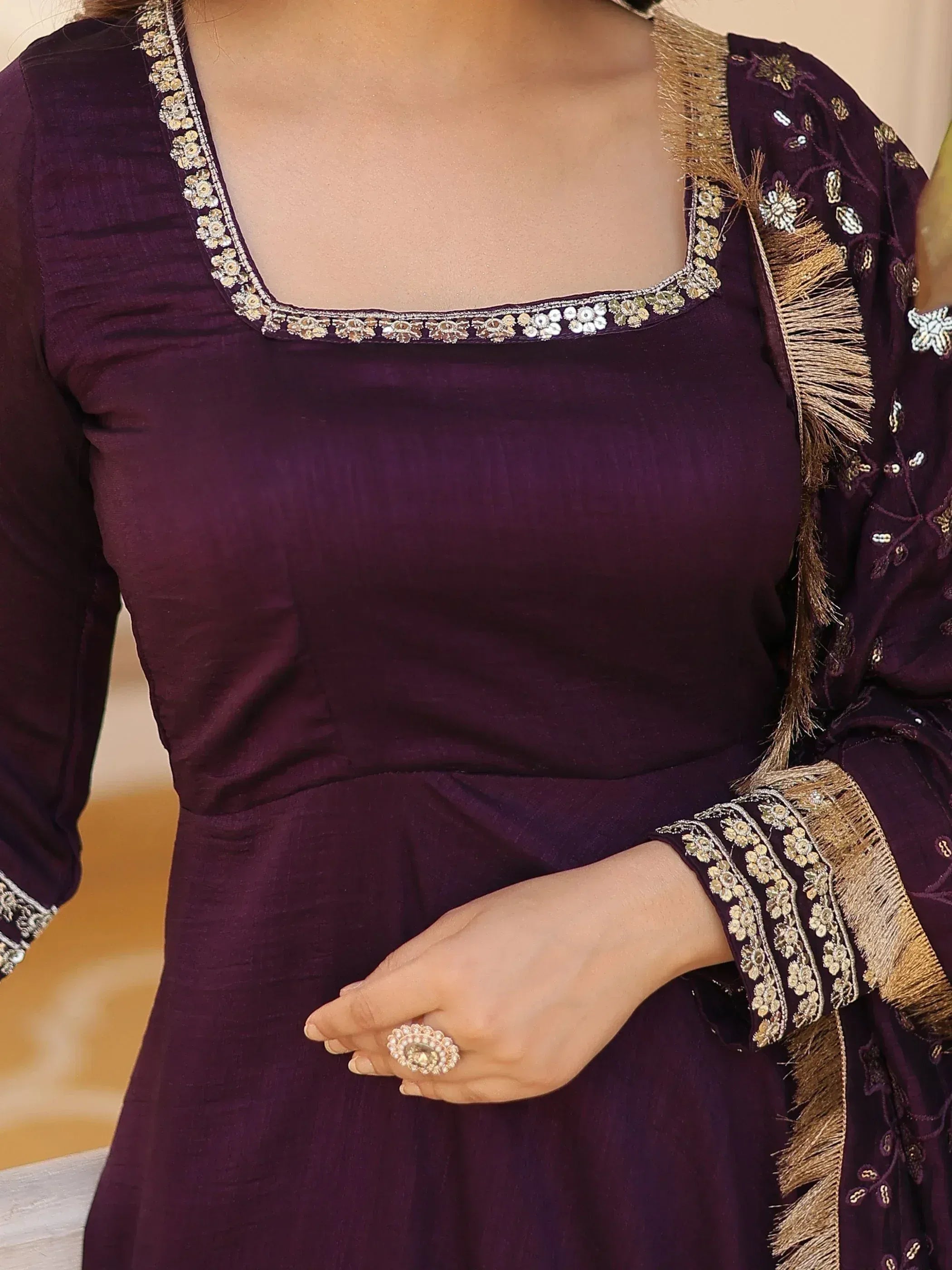 Purple ethnic gown with gold floral embroidery and tassel detailing, perfect for Indian occasions