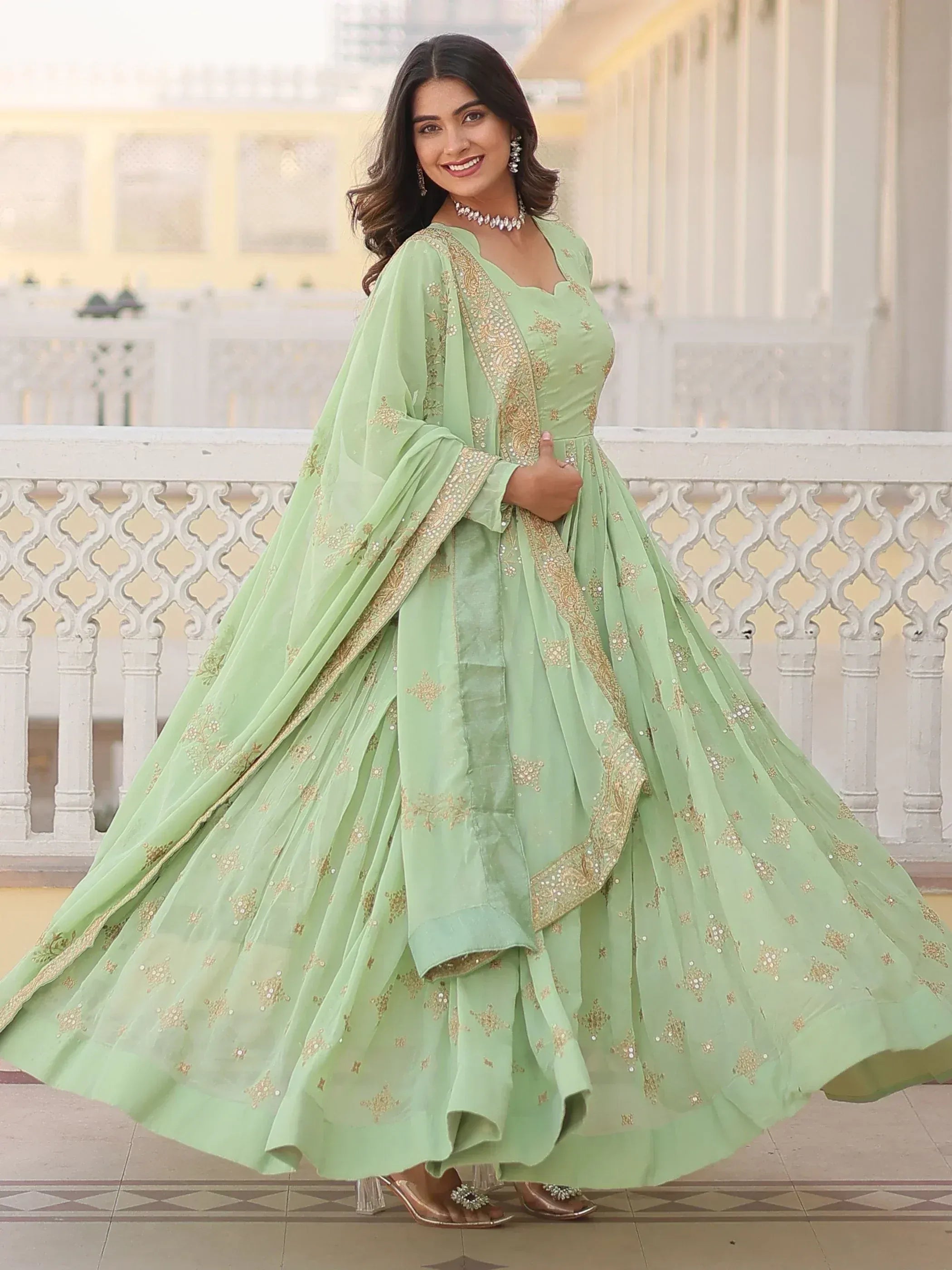 Mint green embroidered lehenga choli with gold detailing, perfect for Indian ethnic wear occasions.