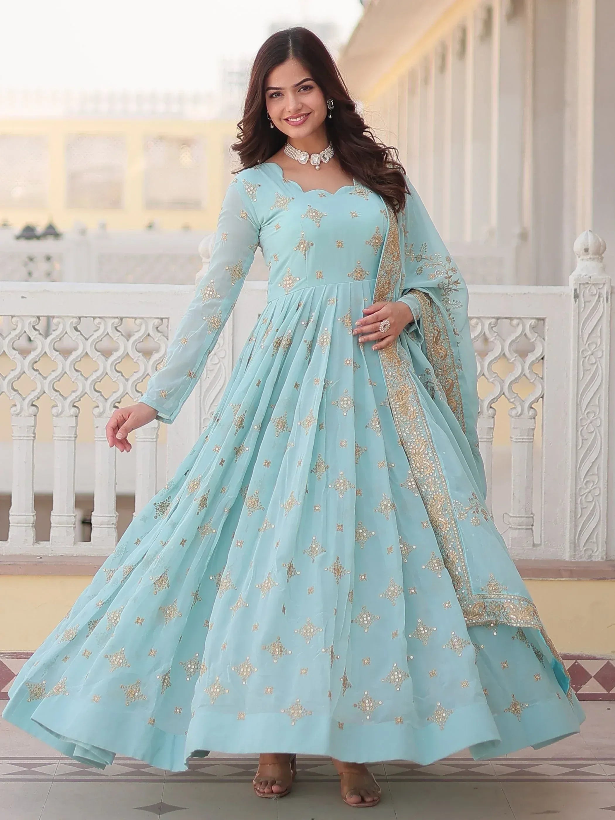 Light blue embroidered anarkali gown with gold detailing, perfect for Indian ethnic wear occasions.