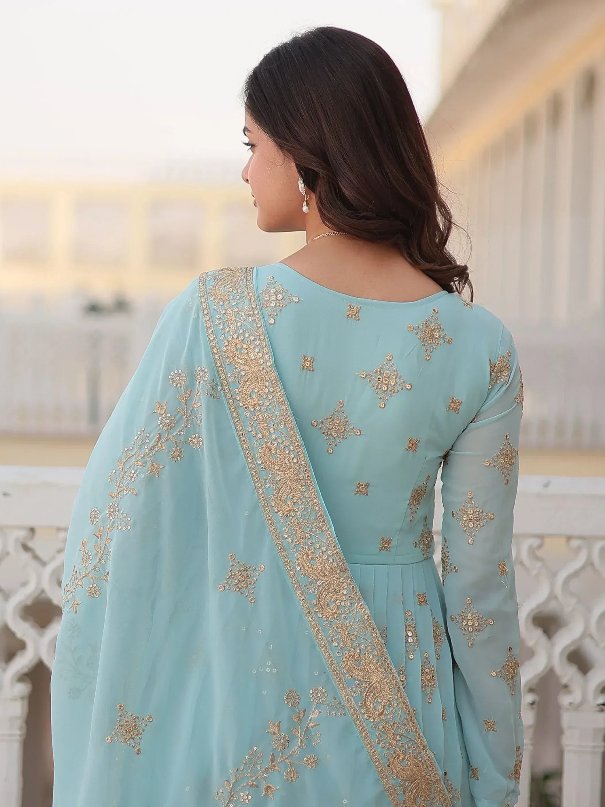 Light blue ethnic anarkali with gold embroidery, perfect for Indian weddings or festive occasions.