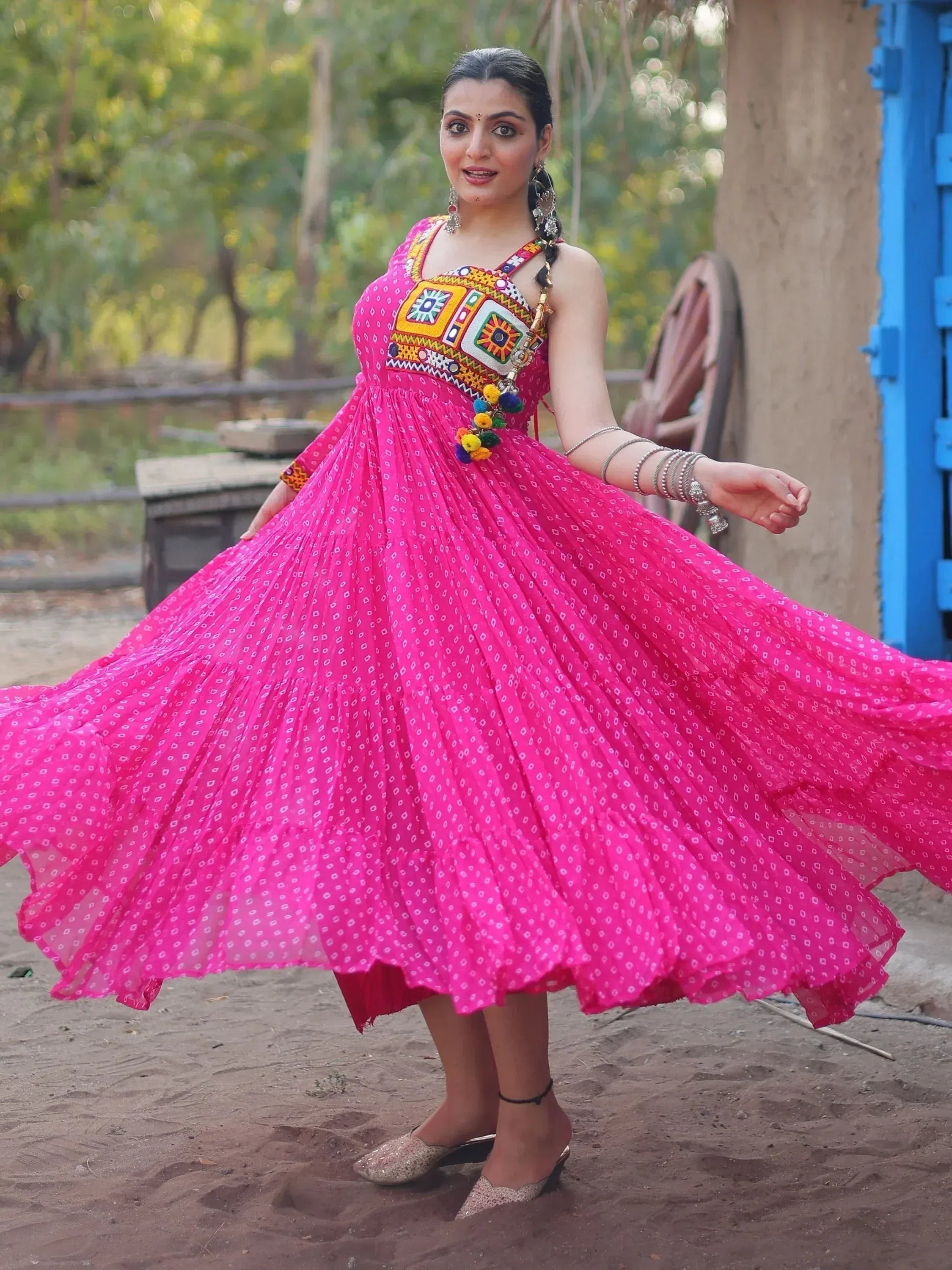 Vibrant pink ethnic gown with mirror work, perfect for Indian festivals and celebrations