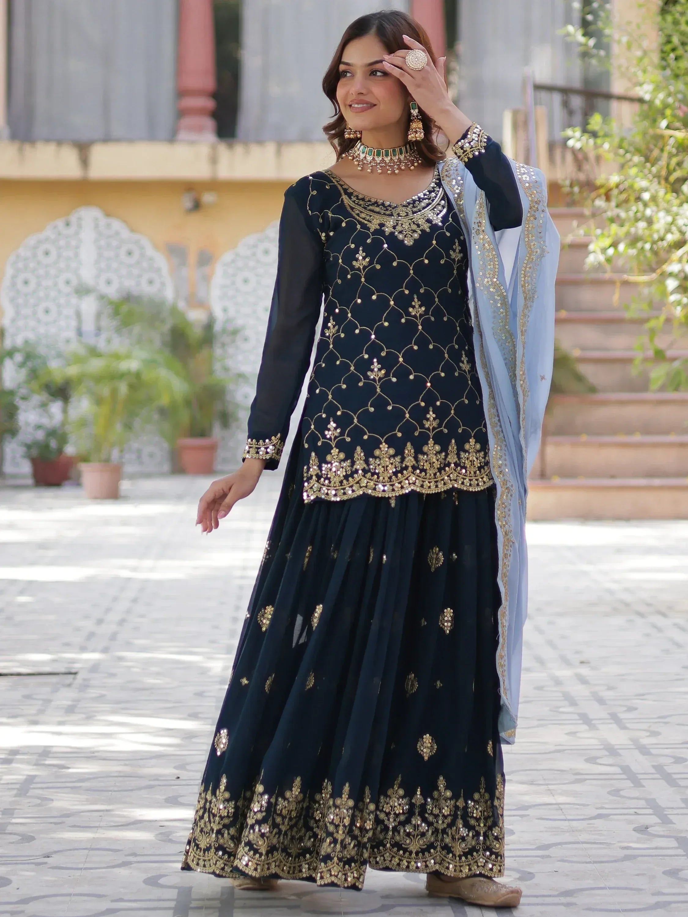 Navy blue embroidered anarkali with gold detailing, paired with light blue dupatta, perfect for Indian ethnic occasions.