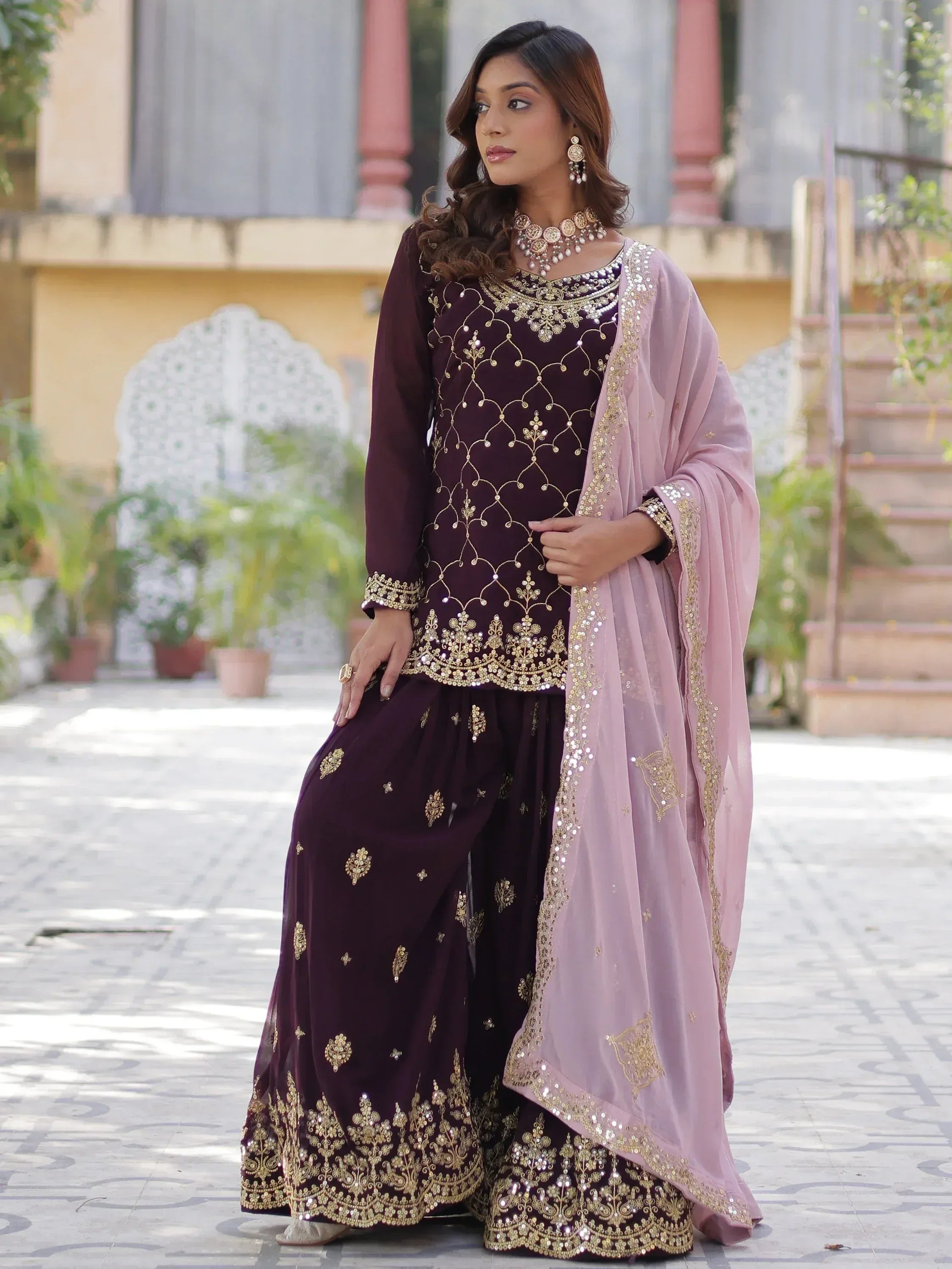 Elegant purple Indian ethnic wear with gold embroidery and pink dupatta, perfect for festive occasions.