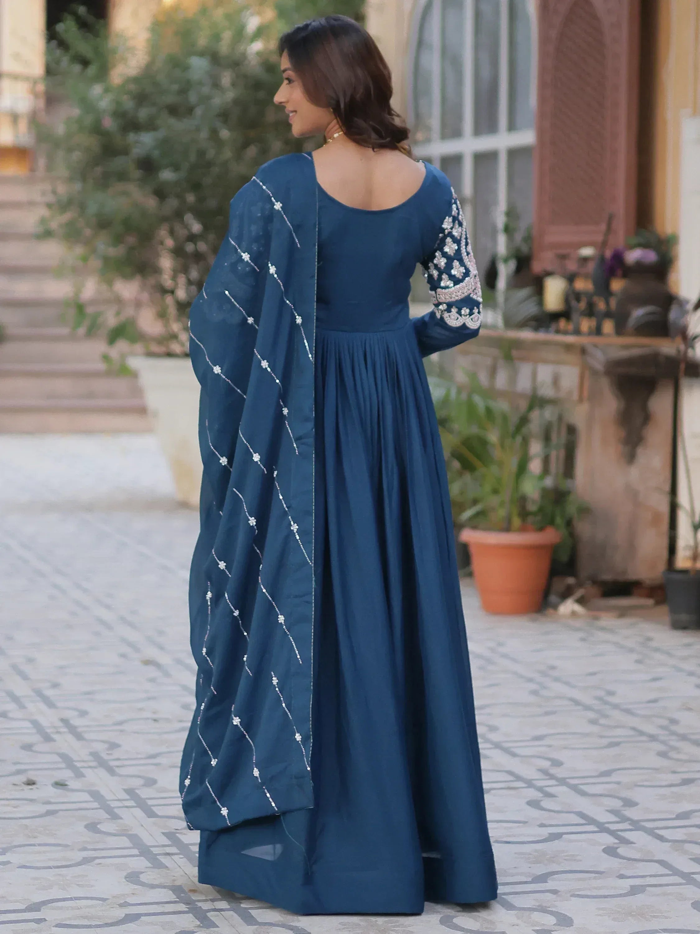Navy blue ethnic gown with embroidered sleeves and dupatta, perfect for Indian occasions