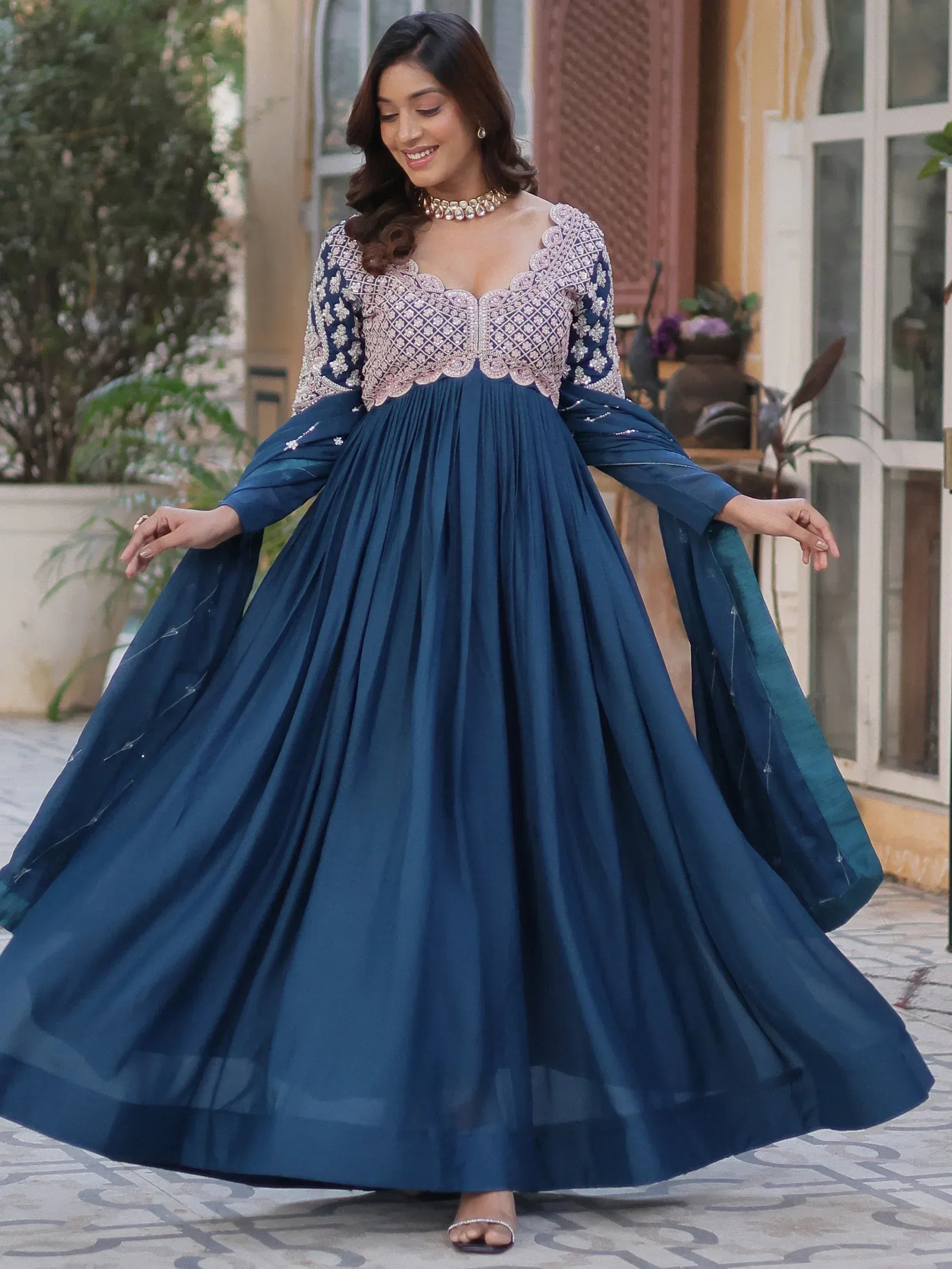 Elegant navy blue ethnic gown with intricate embroidery, perfect for Indian weddings and festive occasions.