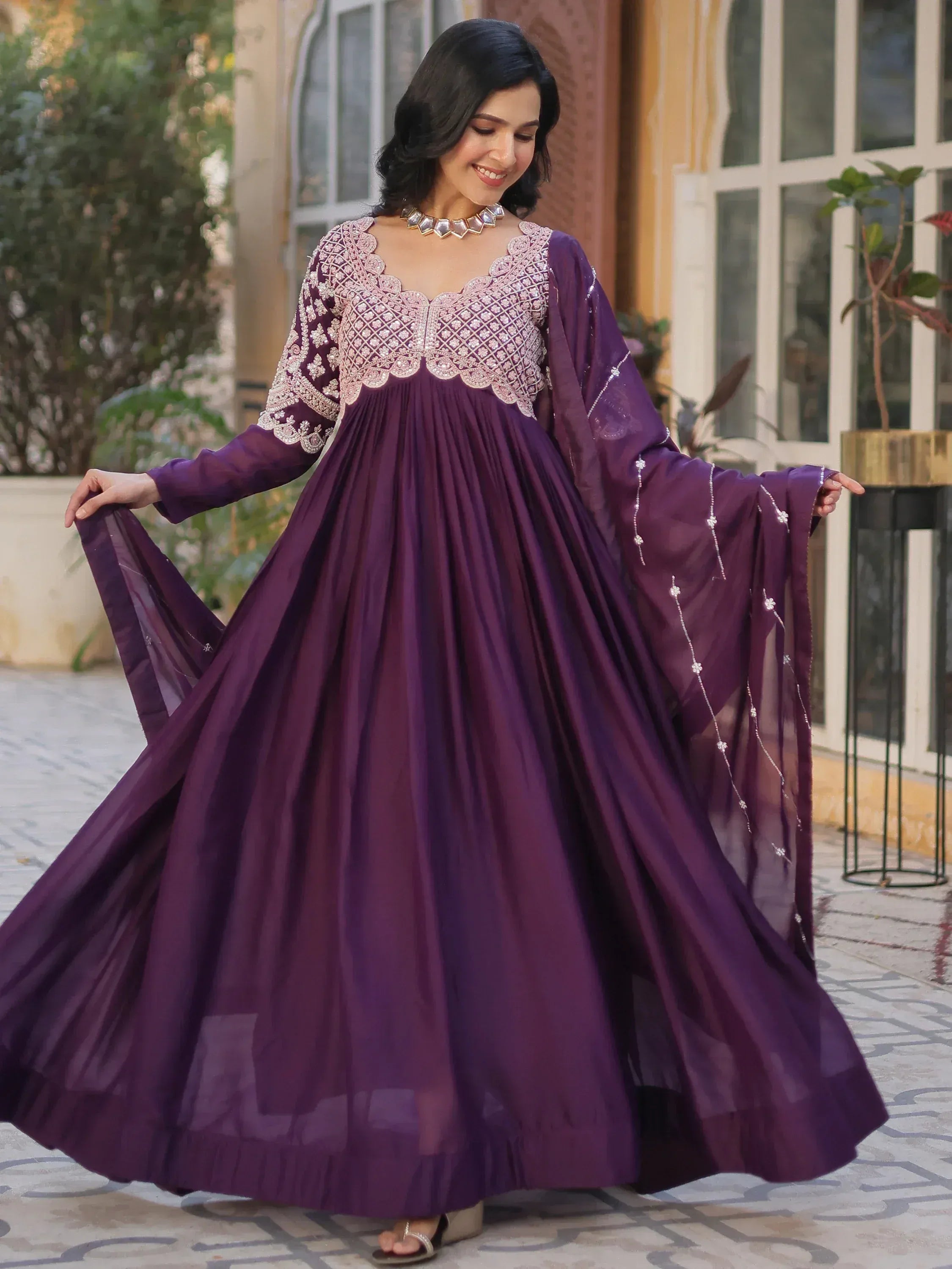 Elegant purple ethnic gown with intricate embroidery, perfect for Indian celebrations and festive occasions.
