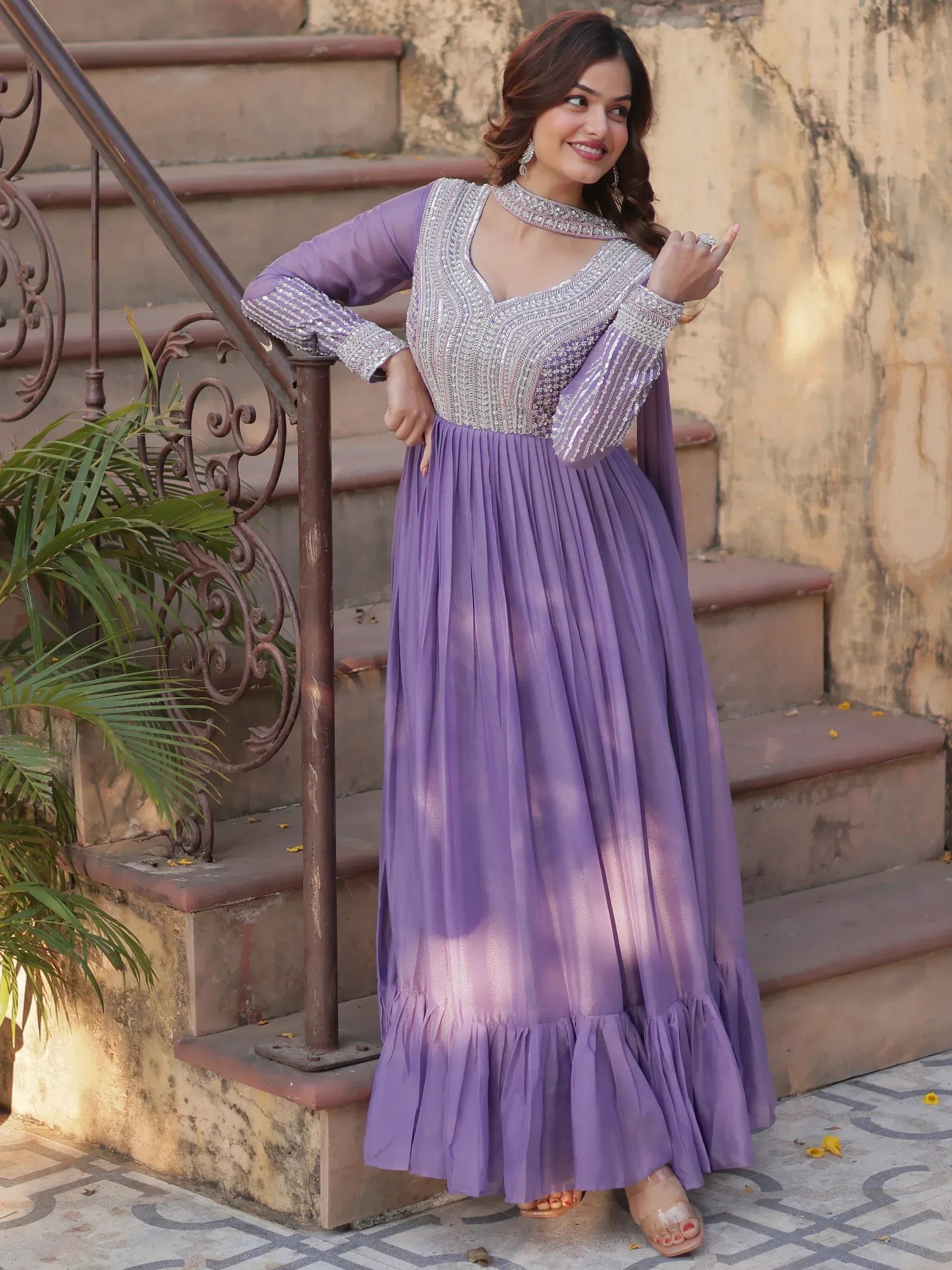 Lavender ethnic gown with silver embroidery, pleated skirt, and choker neckline for festive occasions