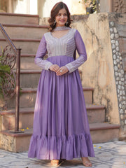 Woman wearing a lavender Indian ethnic gown with silver embroidery, standing outdoors