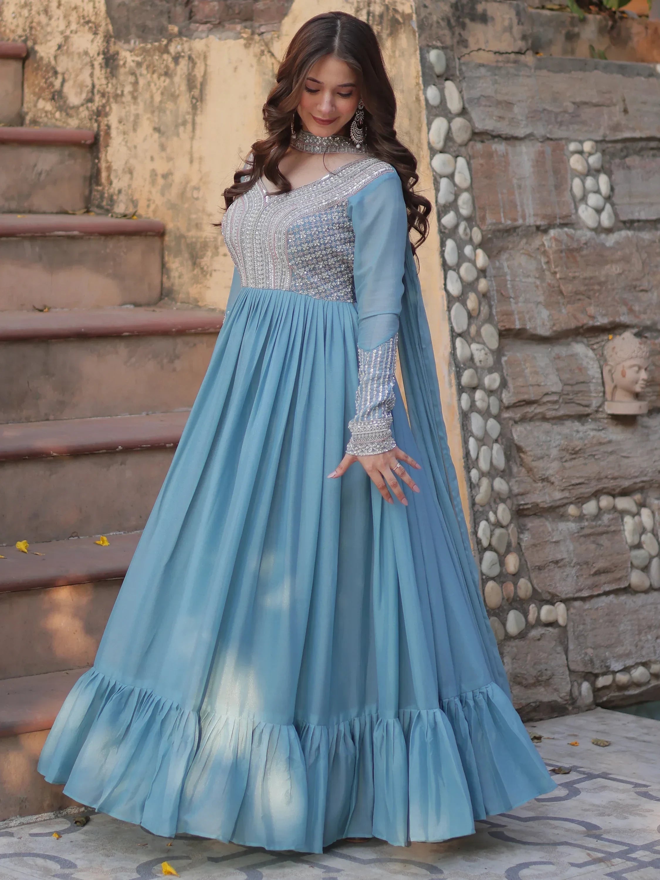 Woman in sky blue Anarkali gown with intricate silver embroidery, ethnic Indian dress