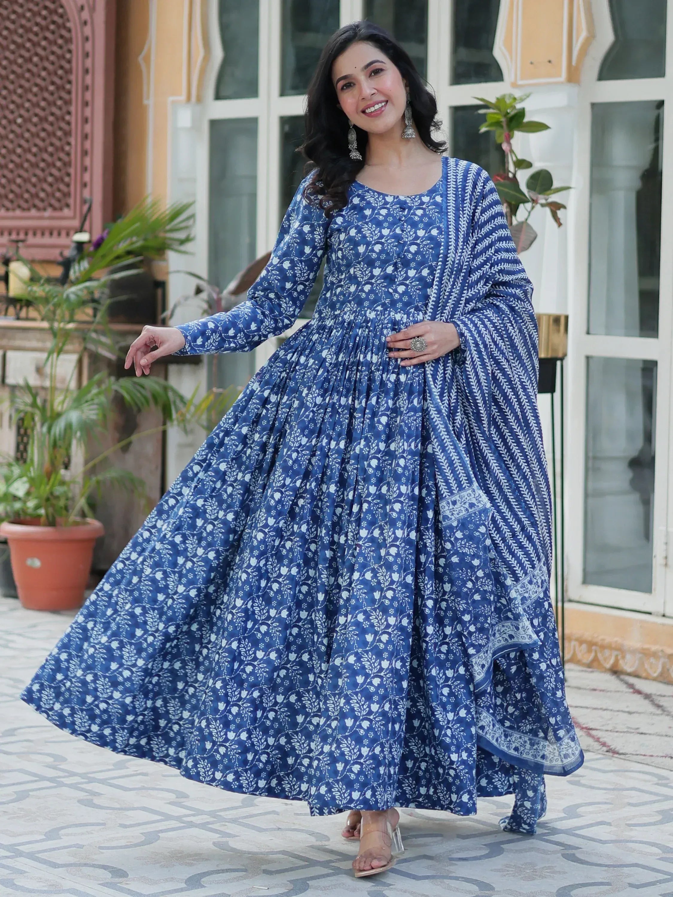 Blue floral print ethnic gown with flared skirt, perfect for festive occasions and traditional wear.