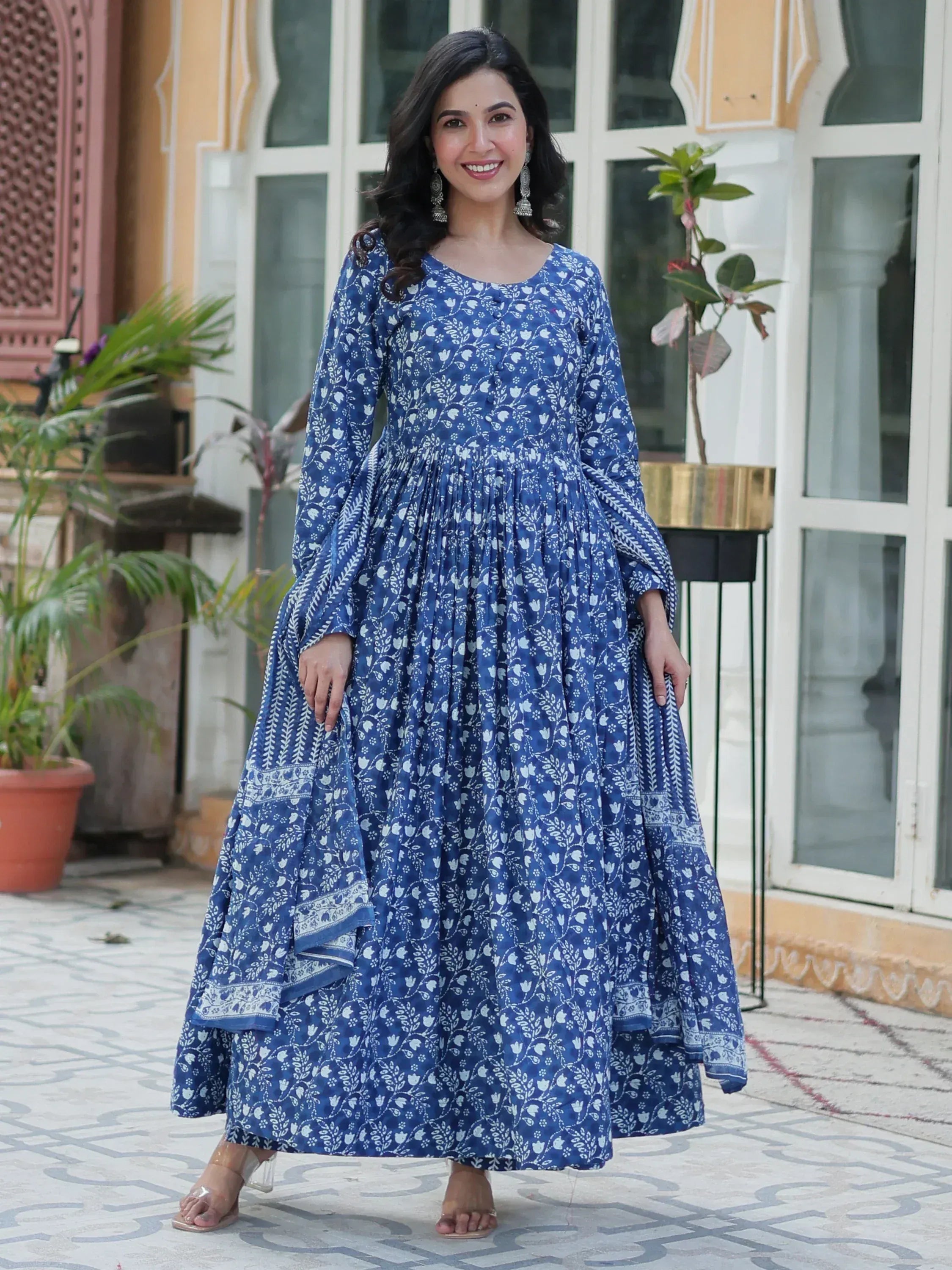 Blue floral printed ethnic gown with flared sleeves and pleated skirt