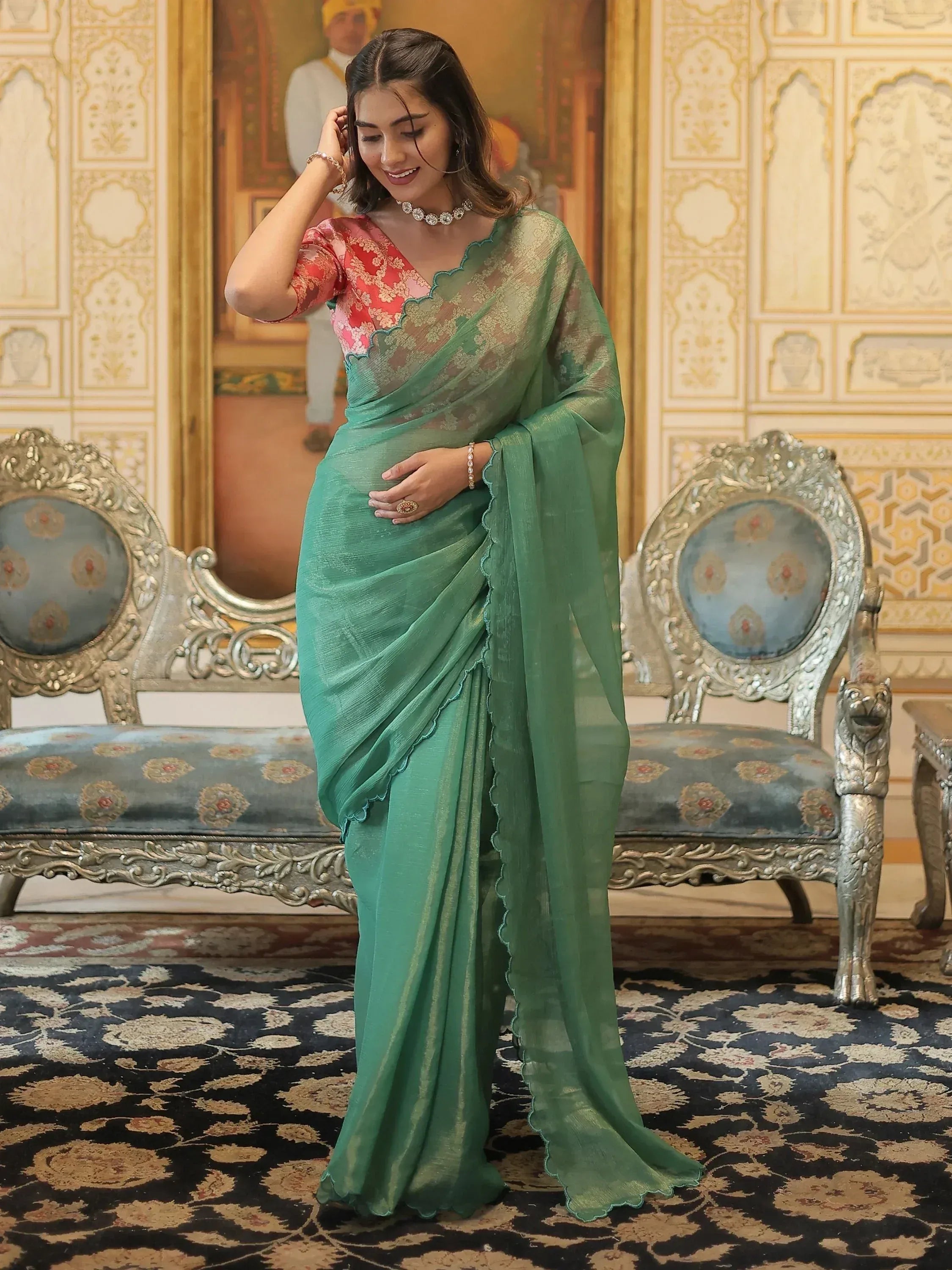 Elegant green saree with scalloped border and floral blouse, styled for Indian ethnic wear occasions