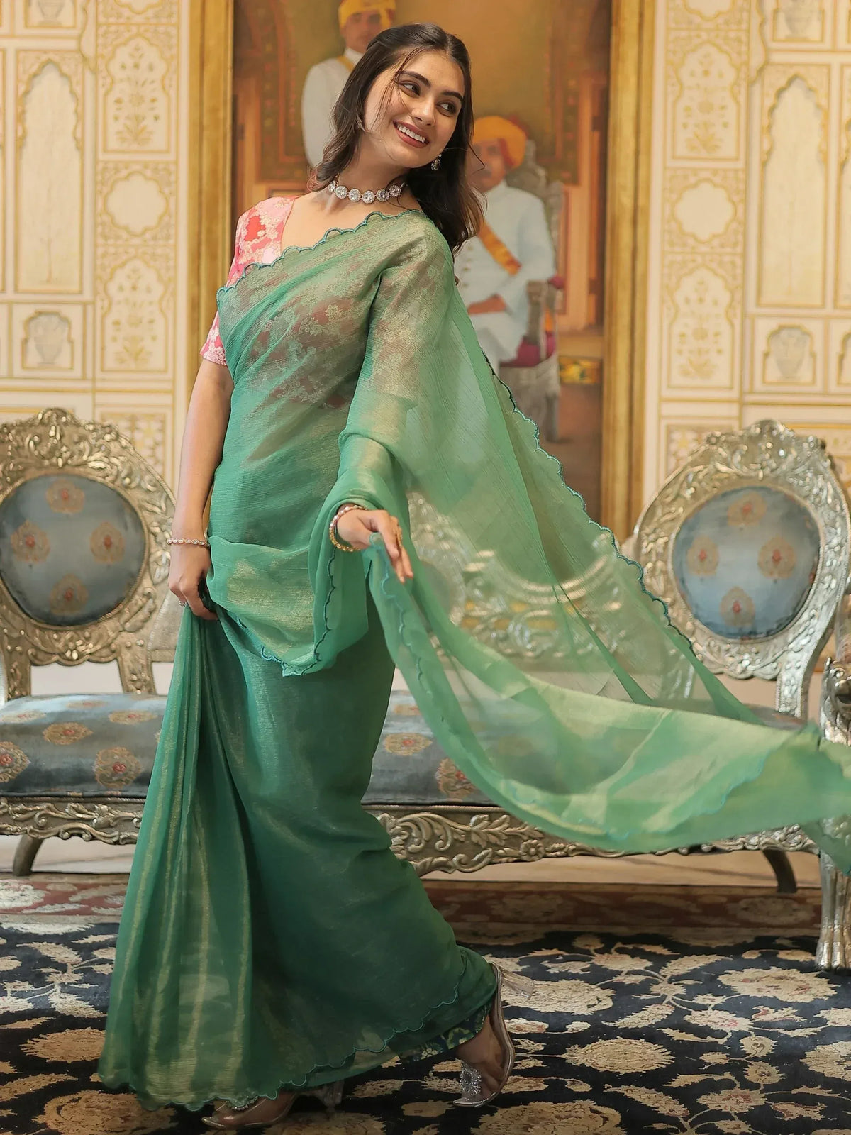 Woman in elegant green ethnic saree with scalloped border, perfect for Indian occasions and festive wear.